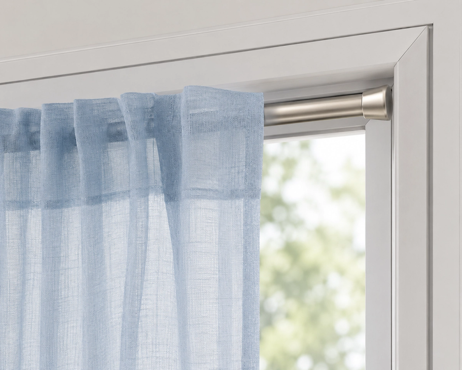 nickel colored tension rod inside a white window frame
