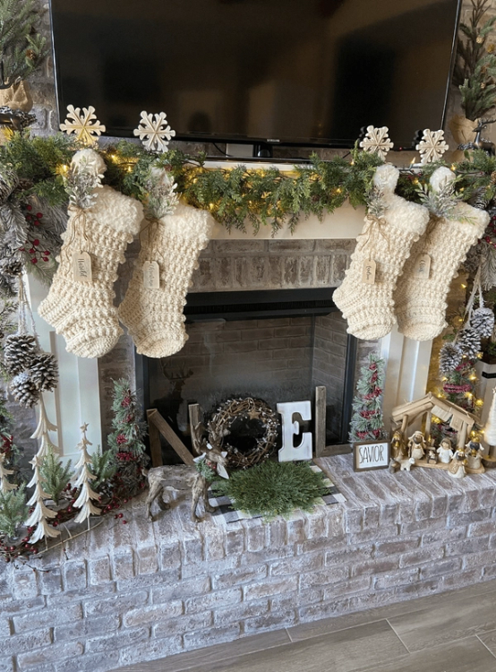 Garland hanging over fireplace on stocking hooks