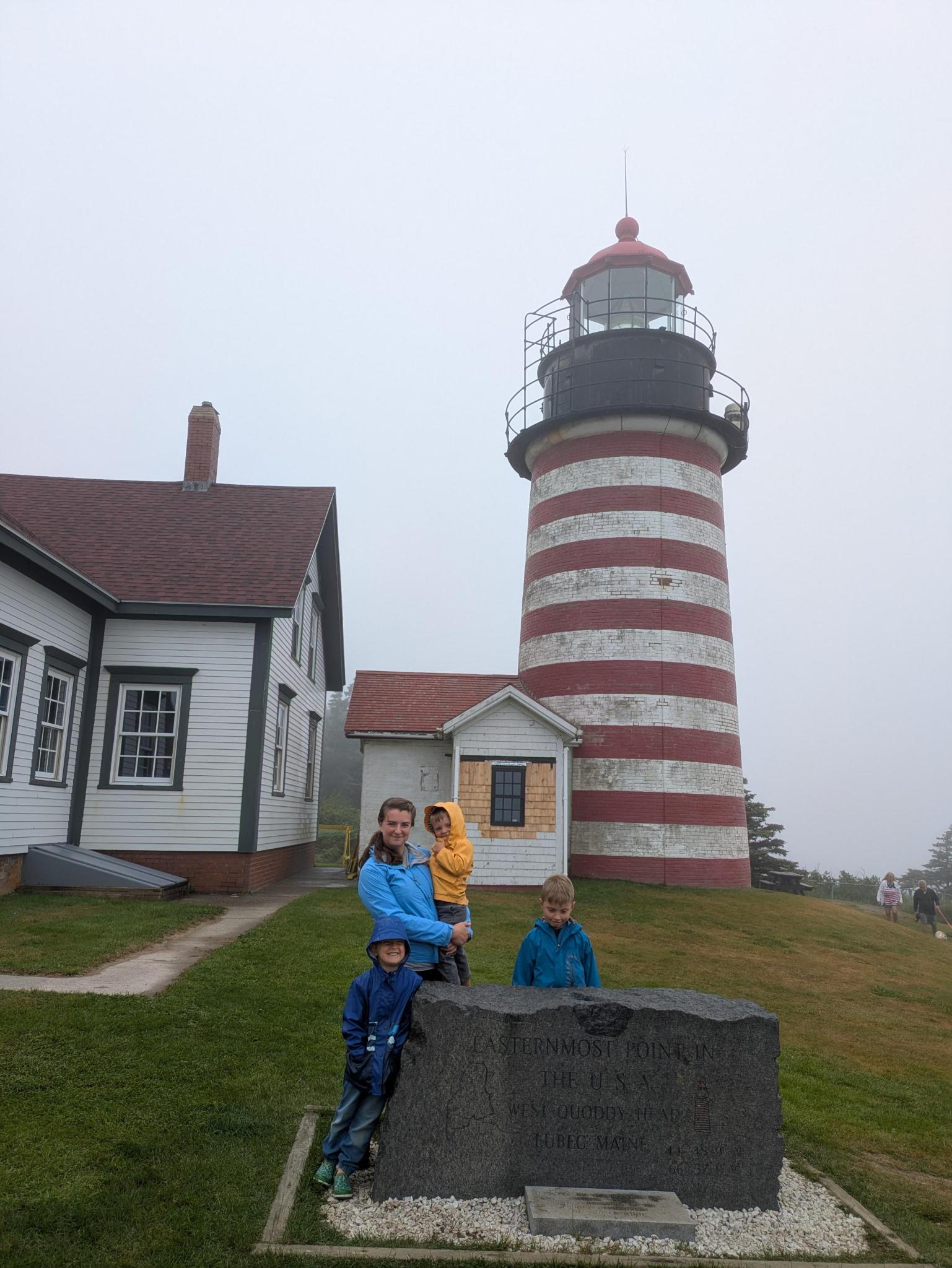 Kameron in front of a lighthouse.