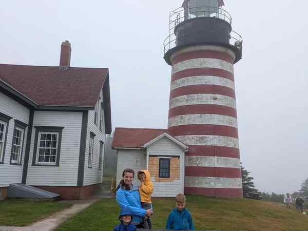 Kameron in front of a lighthouse.