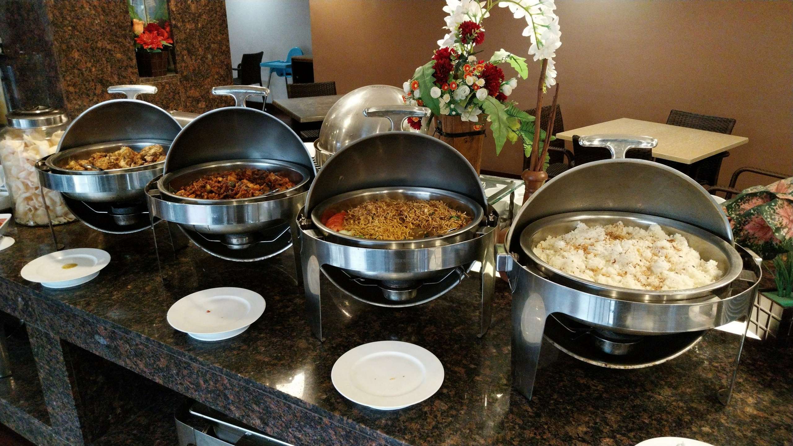 Chafing dishes laid out along a buffet counter
