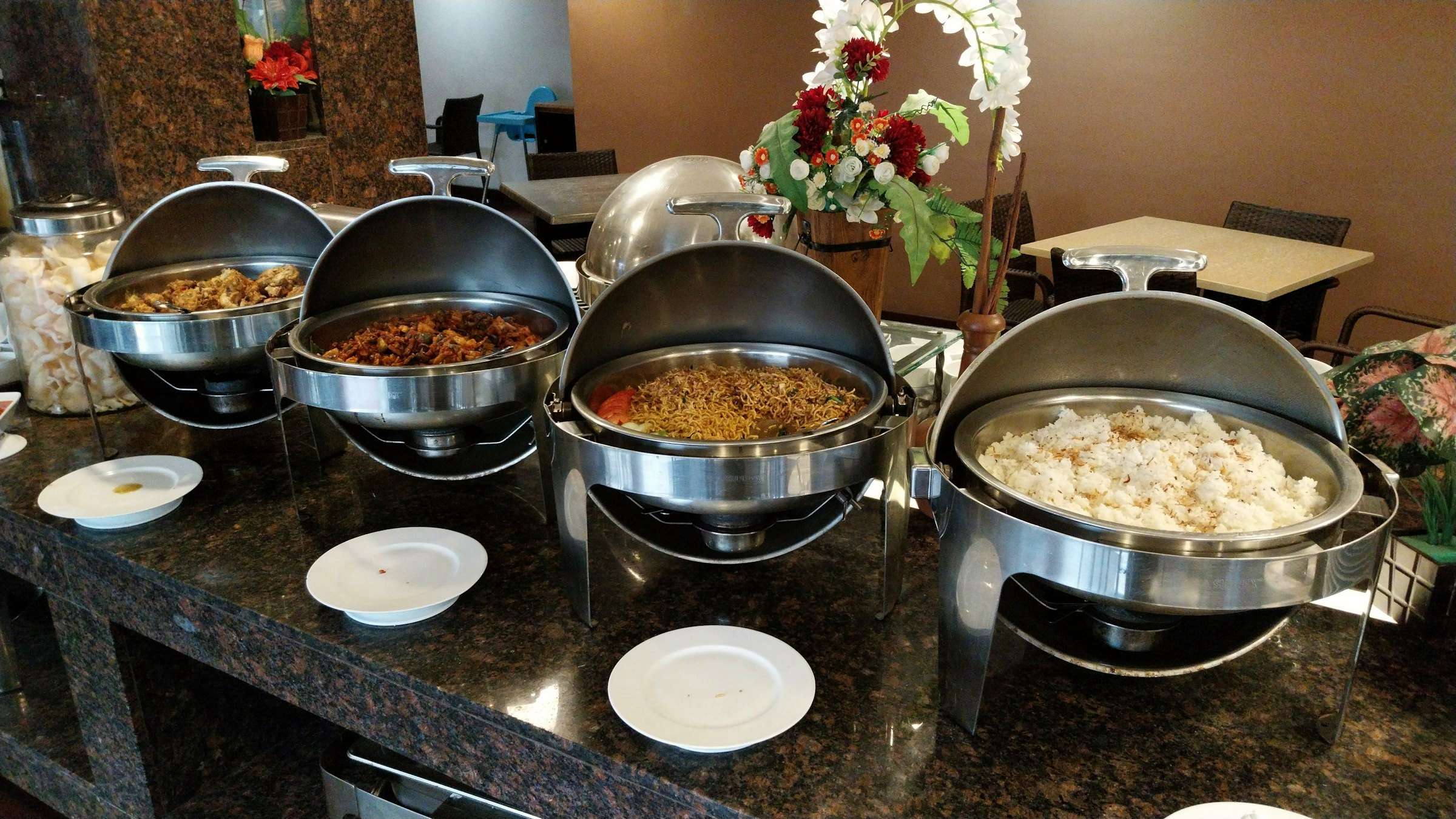 Chafing dishes laid out along a buffet counter