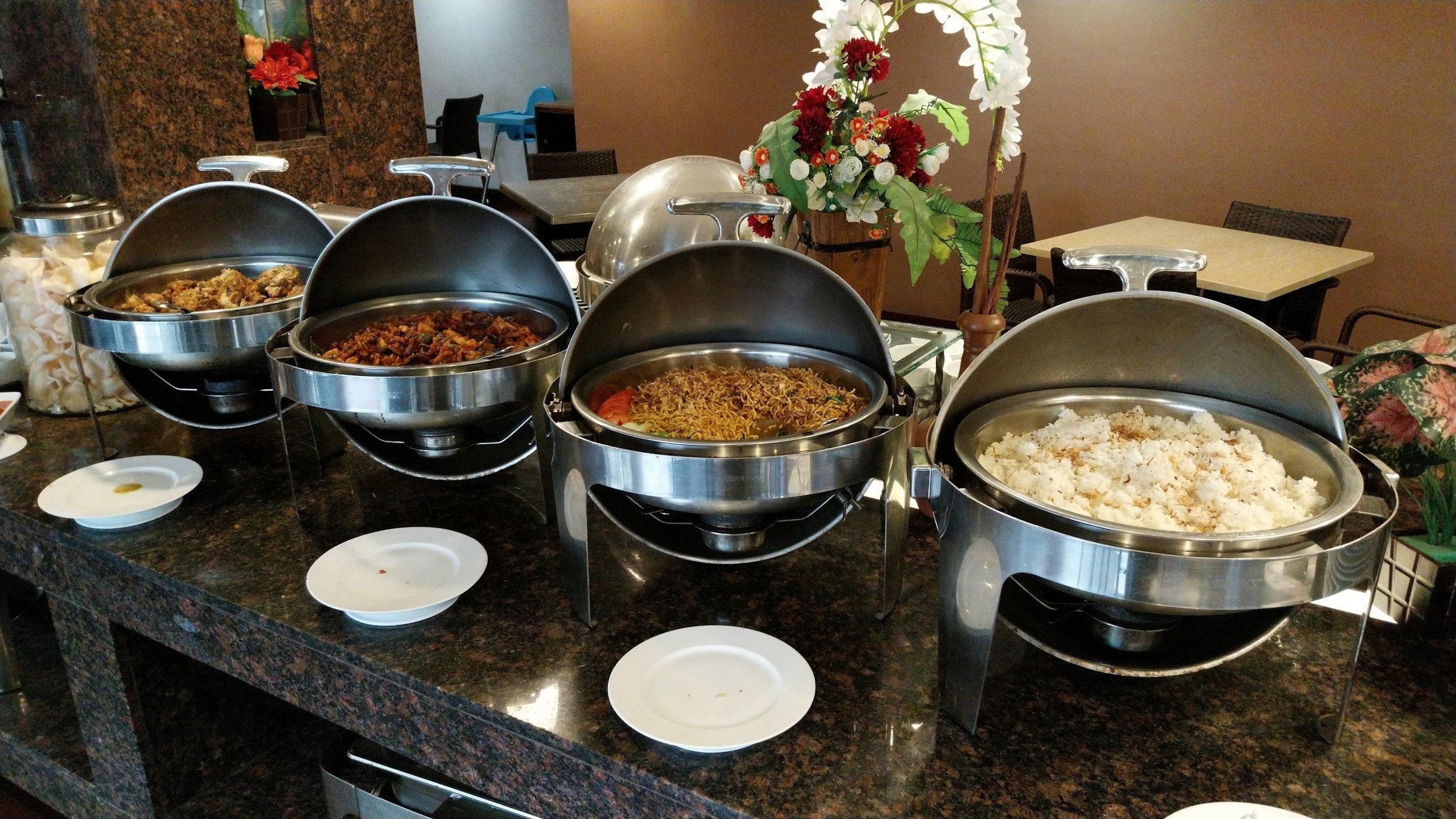 Chafing dishes laid out along a buffet counter