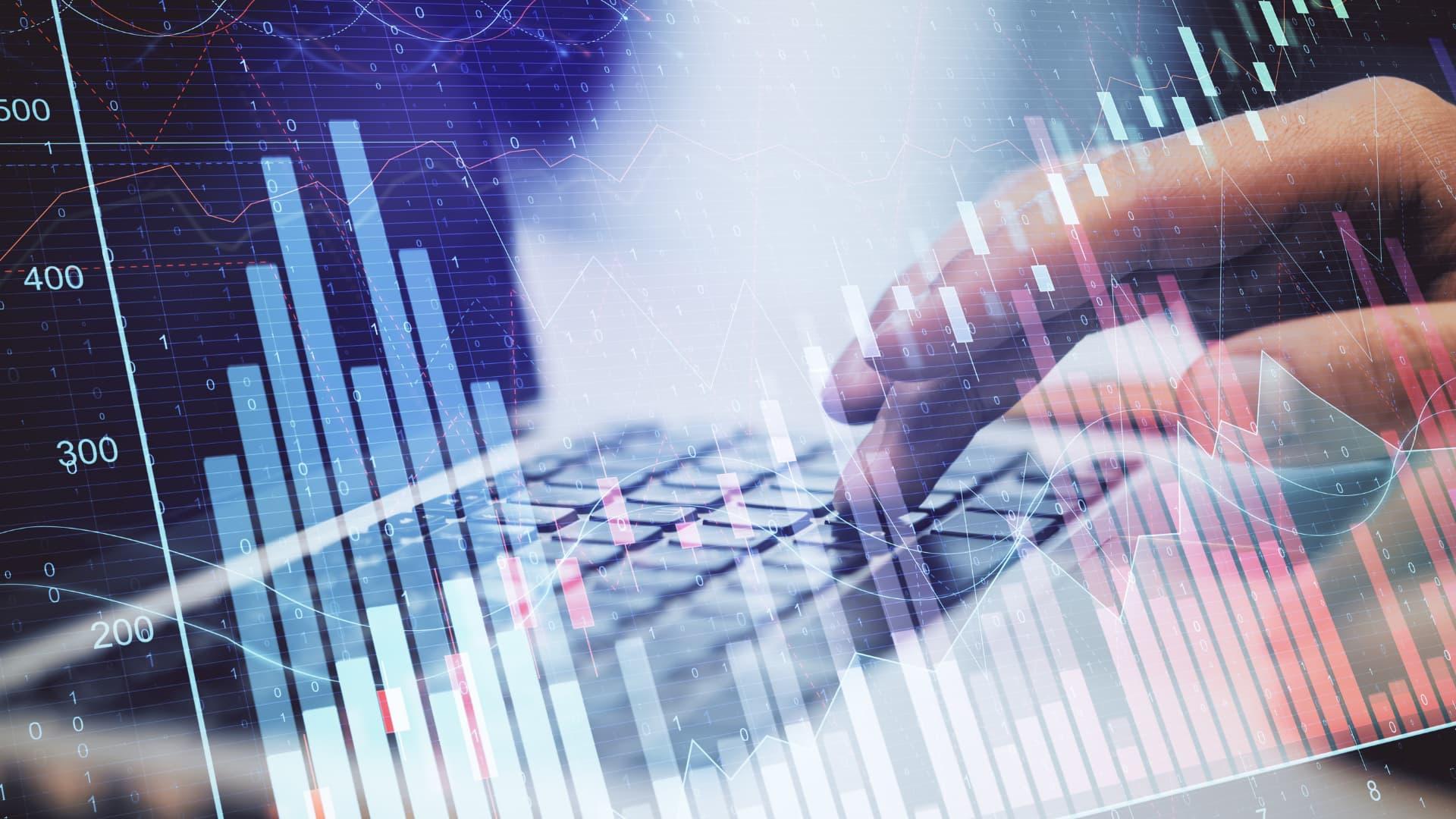 Transparent graph with someone typing behind it