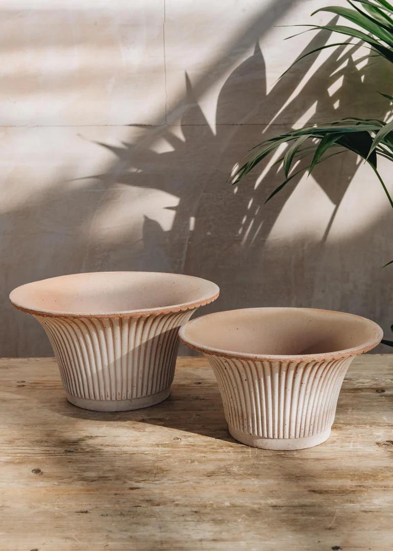 Two Bergs Potter Rosa Daisy Pots. The terracotta pots have a slightly fluted shape with grooves around the entire pot. 