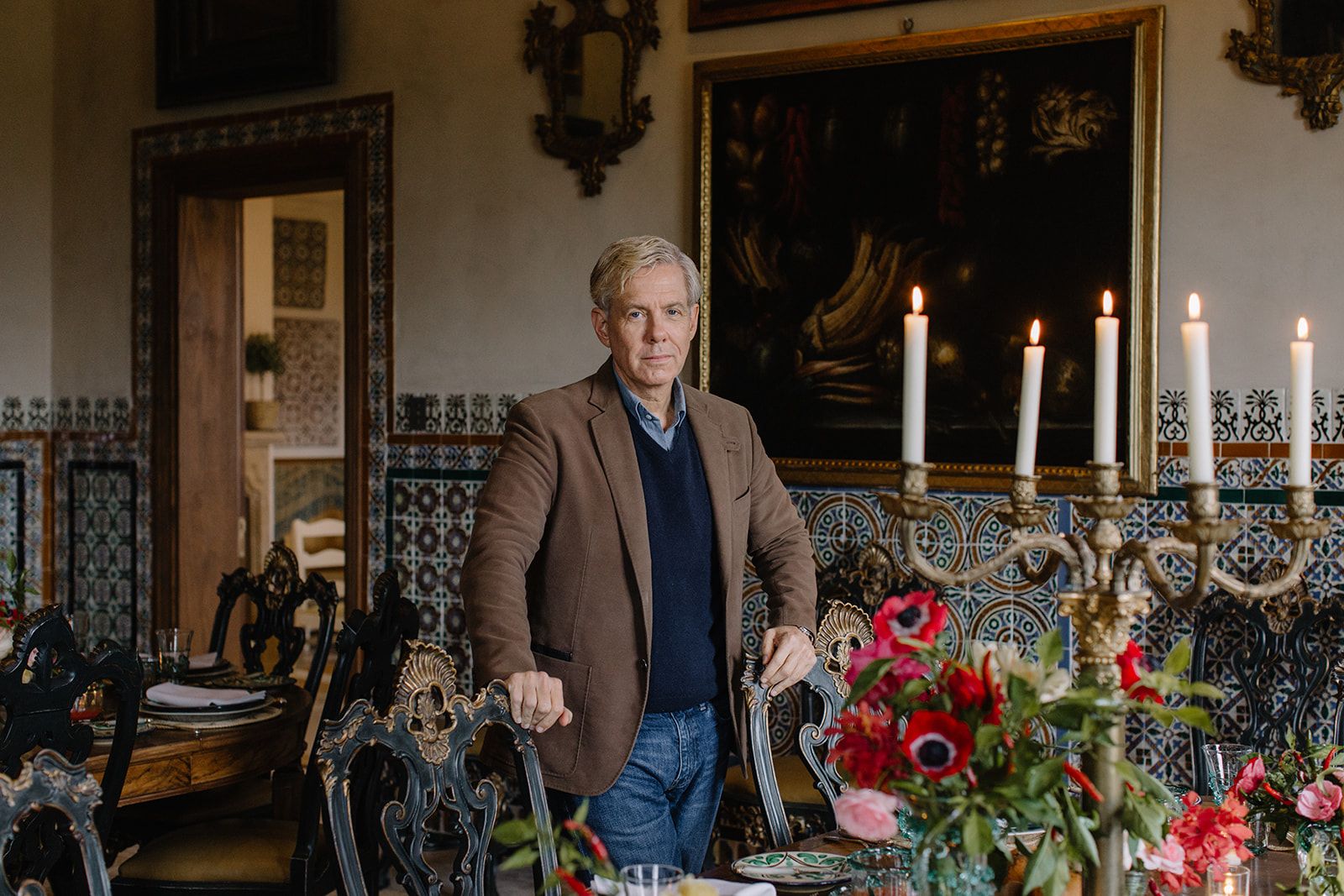 American designer Michael S. Smith stands in his grand dining room in Mallorca. 