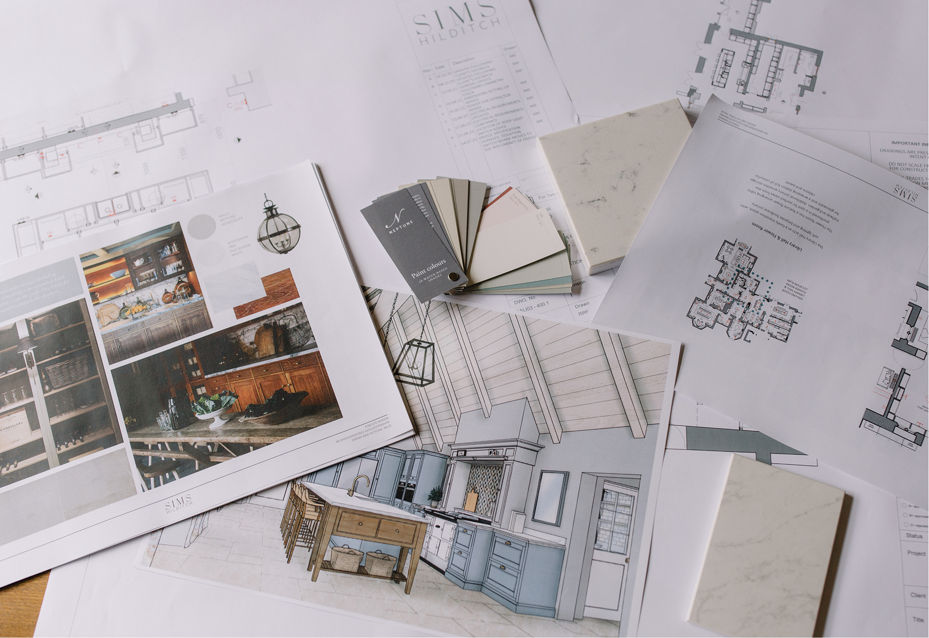 Design plans for Emma Sims-Hilditch's new kitchen are splayed about a table. In the centre is a booklet of Neptune paint swatches.