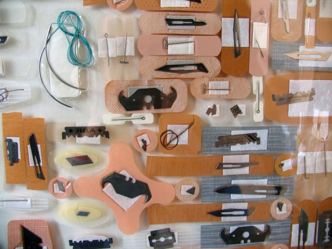 LOVE as a LIST OF VICARIOUS EDGES Series_______surgical scalpels, blades, pins, razors, bandages / various sizes / 2006 — 2010