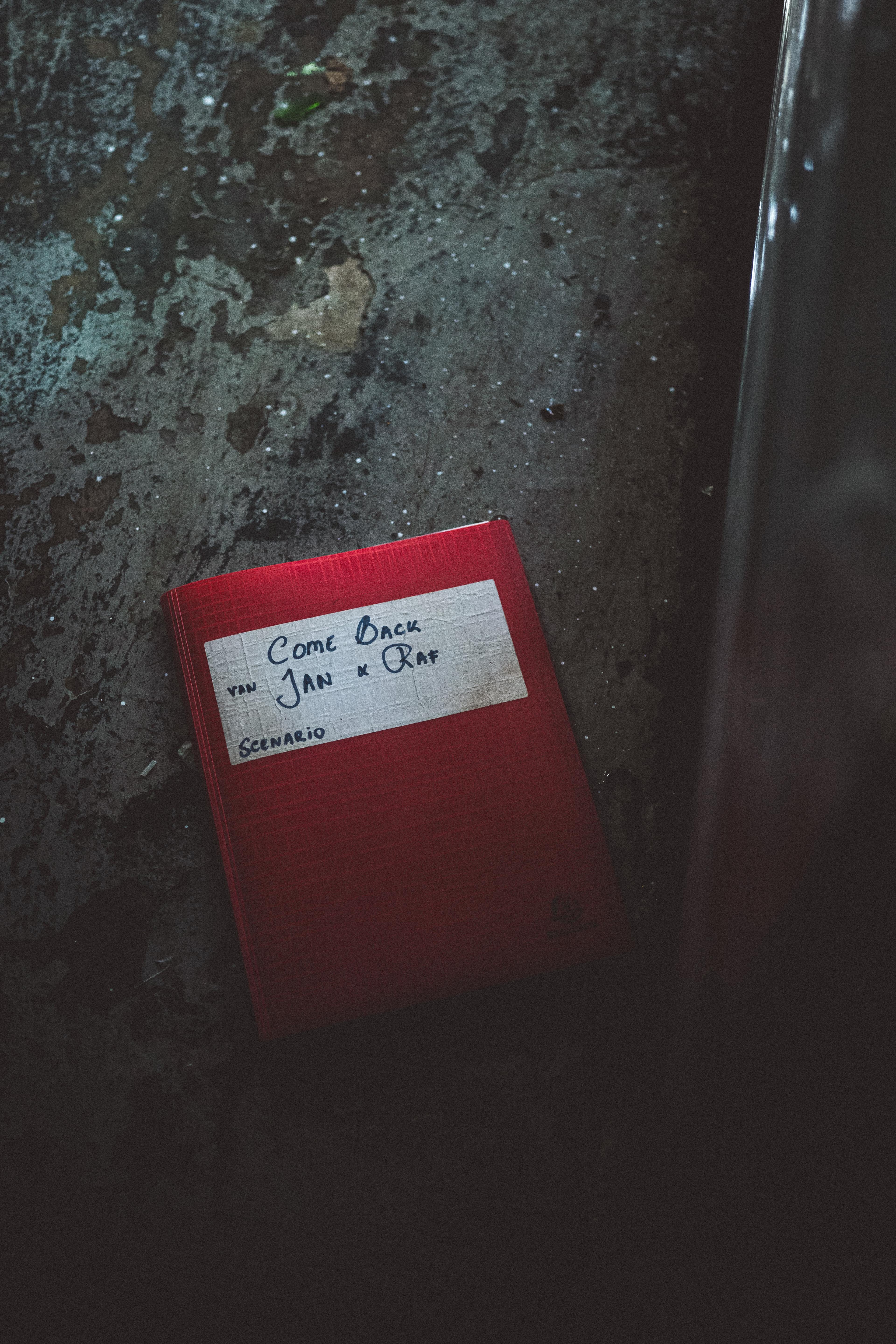 the script of the movie in a a red folder with the names of the directors written on it. 