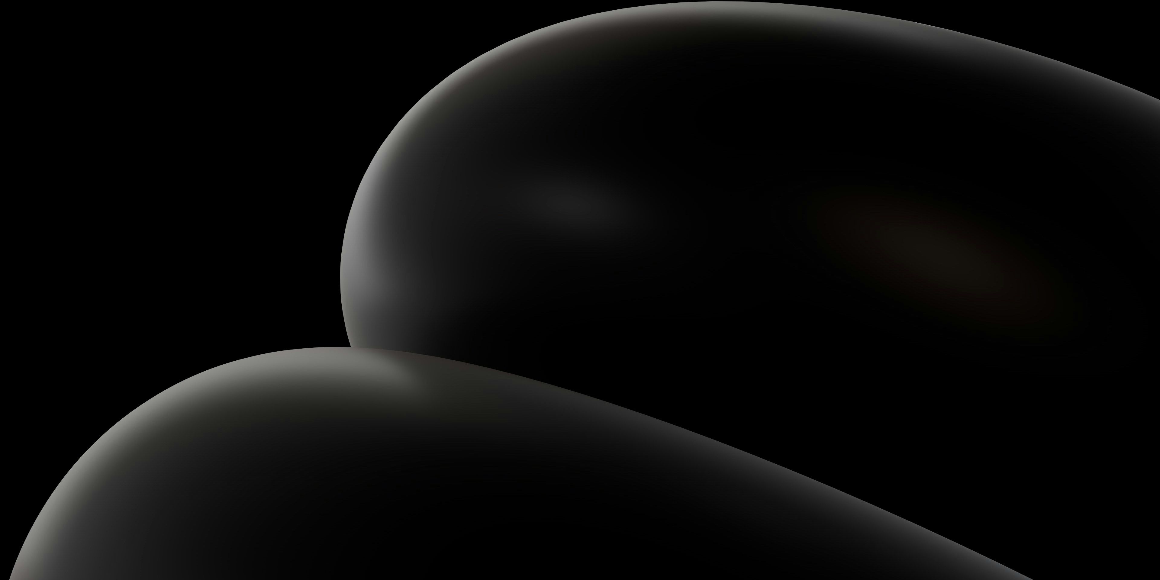 A close up of a black object on a black background .