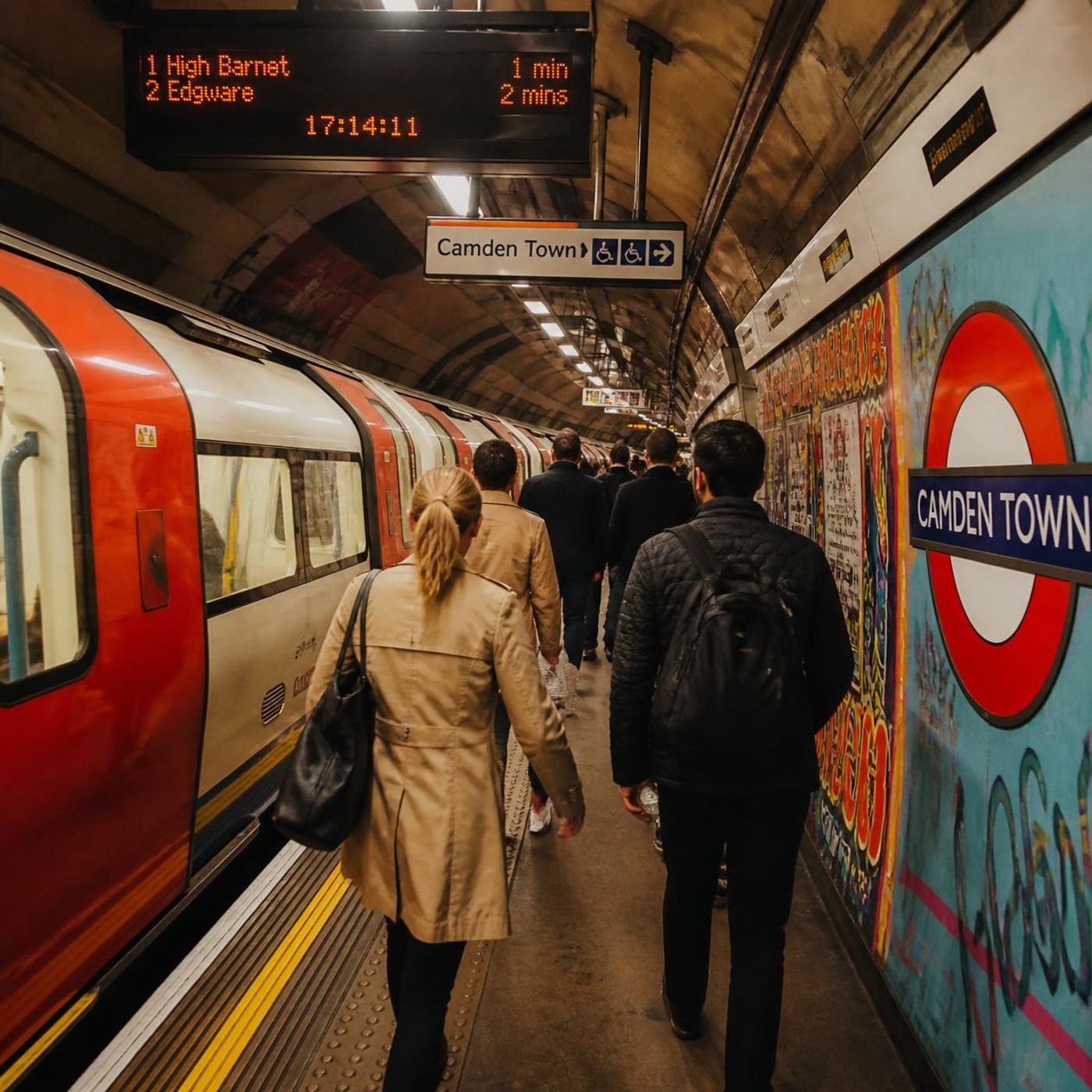 Camden Town London Underground station platform with commuters and a Northern line train