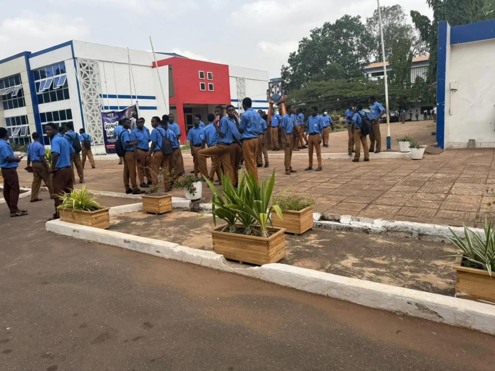 Students in blue school uniforms gathered in a school courtyard during the Global Learning for Africa research project.