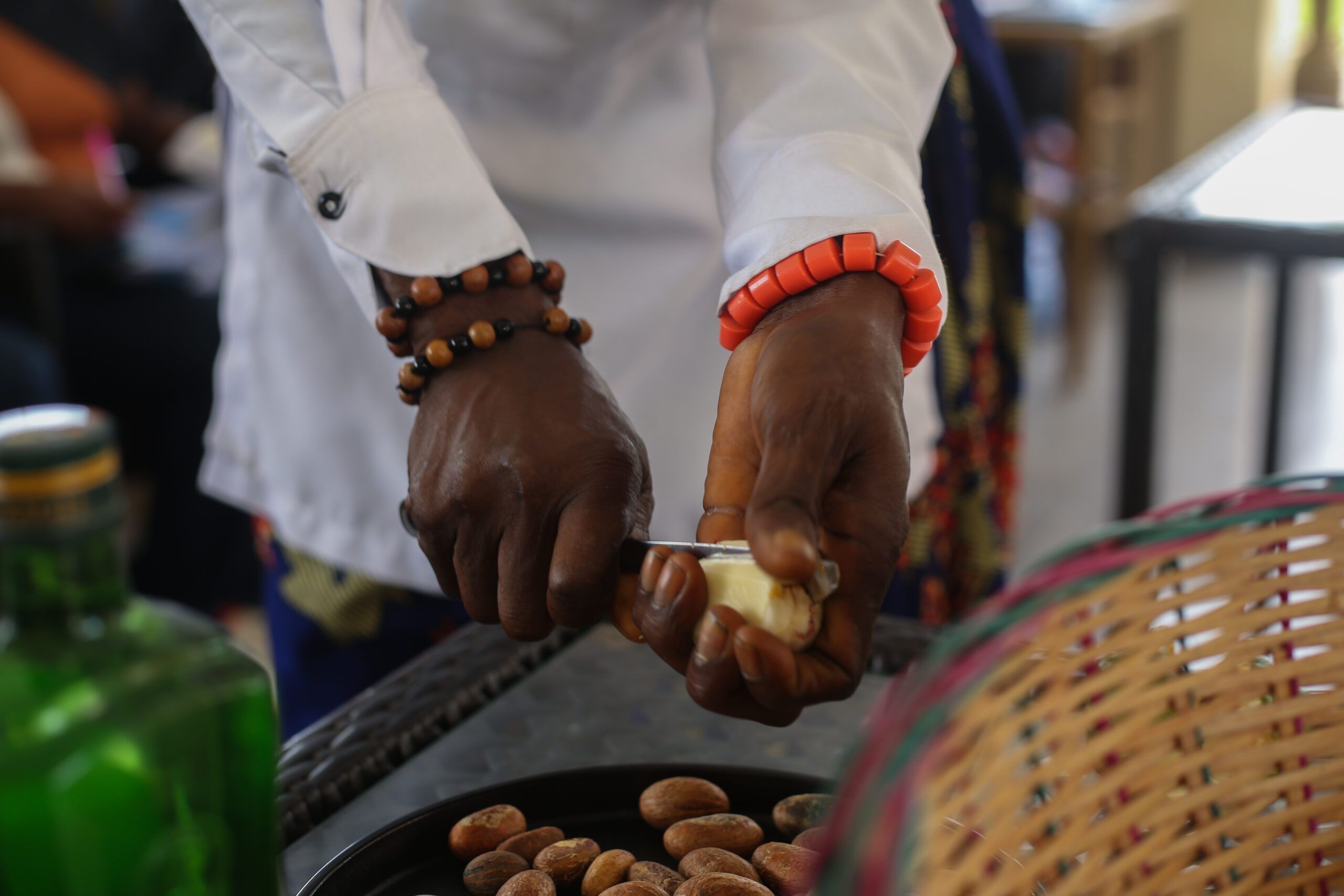 Hands breaking kola nut at the Wisdom Gathering, September 2026