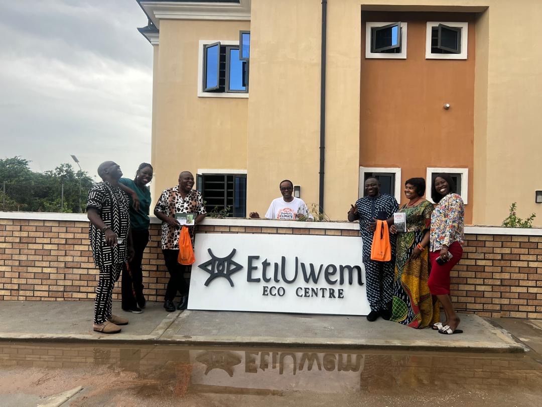 Participants laughing beside the EtiUwem Eco Centre sign