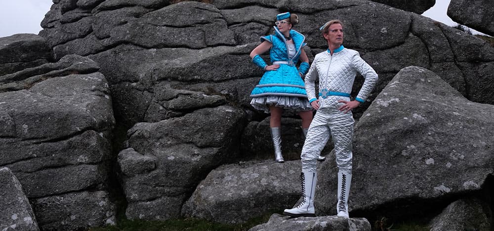 Sarah and Philip on Bonehill in Dartmoor wearing space uniforms.