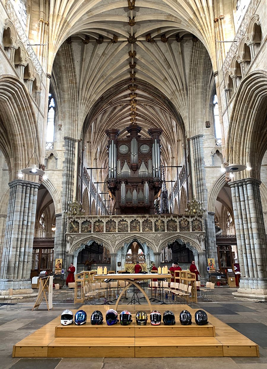 Motorcycle helmets lined up on the altar inside Exeter Cathedral