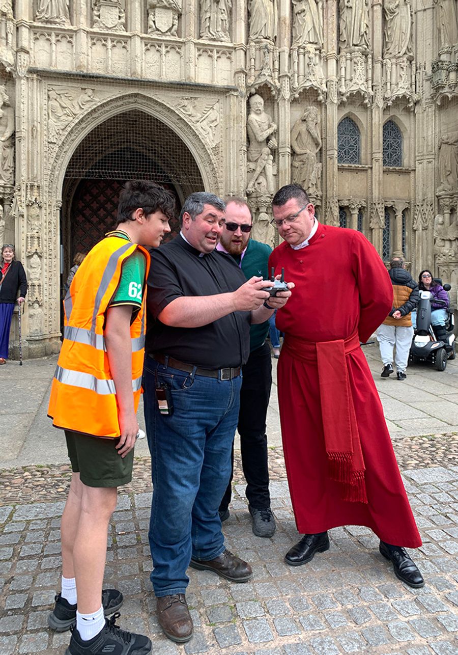 Father Matthew Cashmore with steward ad clergy, flying a drone