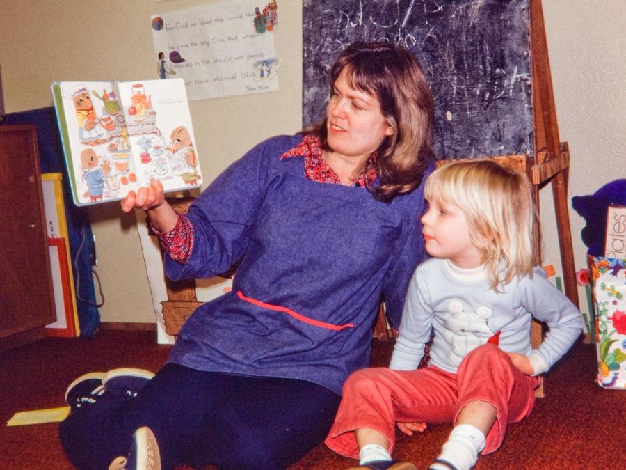 My pre-school teacher, Mrs Whitmer, reading a book