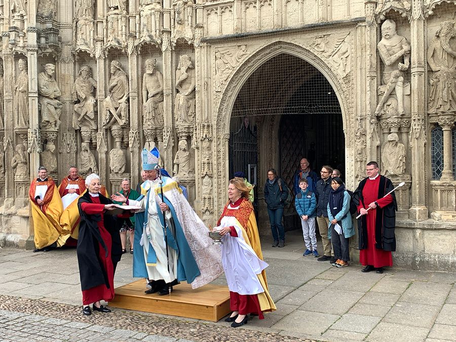 Bishop Mike in front of Exeter Cathedral, preparing to bless the bikes