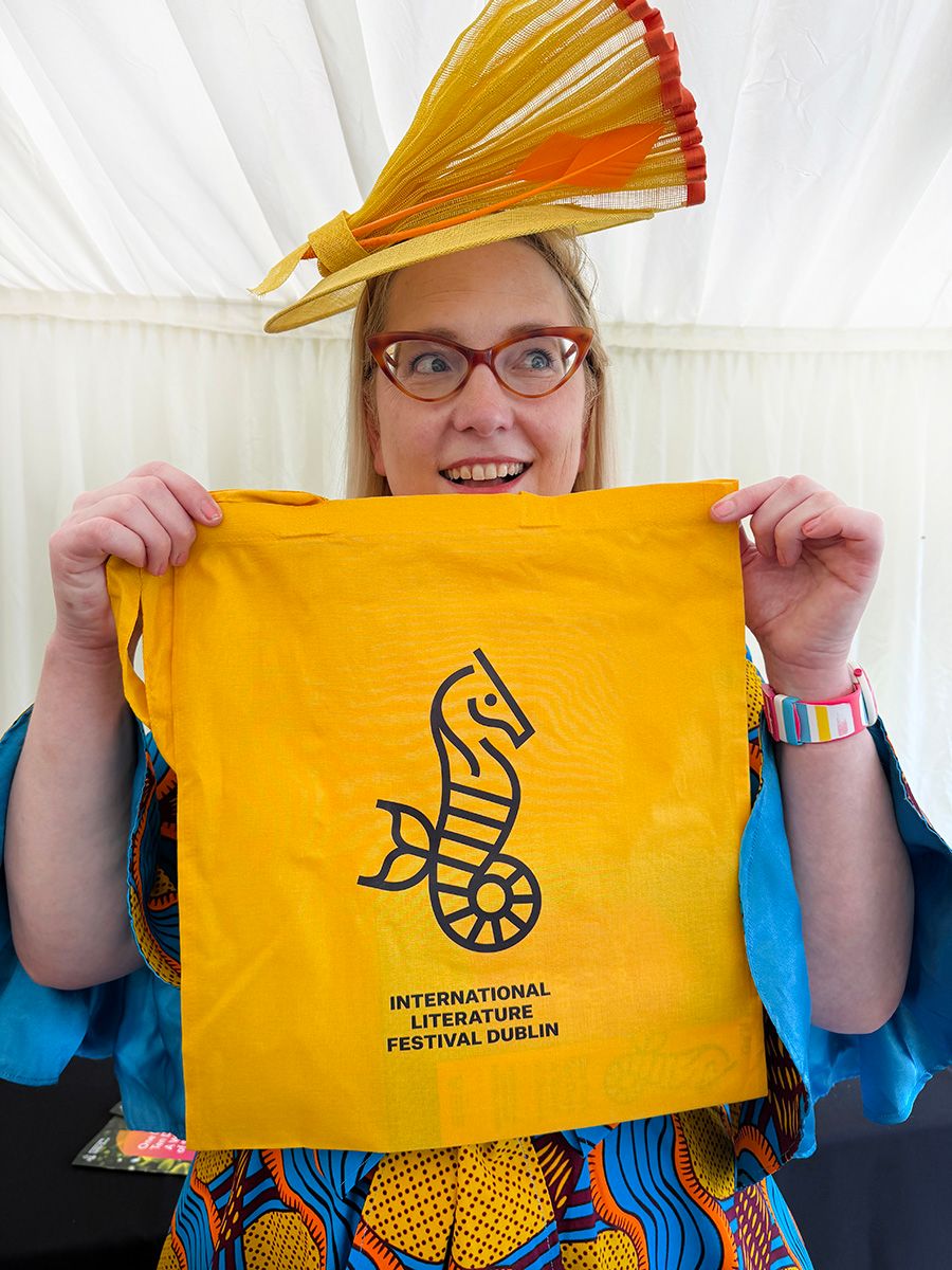 Sarah holding a Dublin Lit Fest bag with its seahorse logo