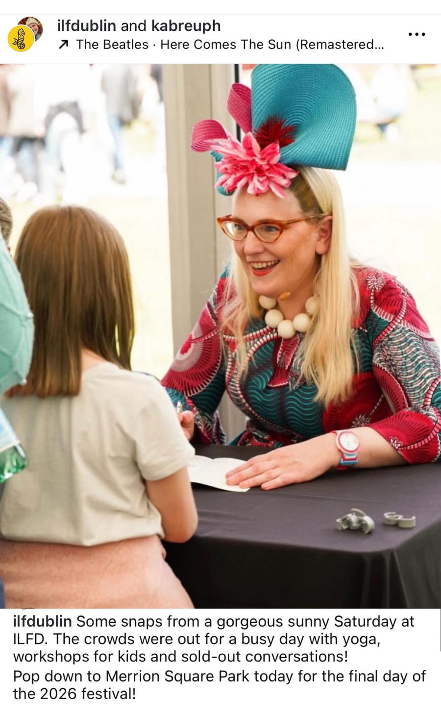 Festival photo of Sarah McIntyre signing a book for a child