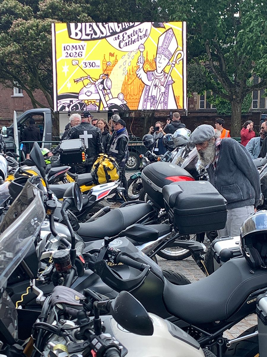 Foreground full of motorbikes; in the background a screen with Sarah McIntyre's illustration displayed on it