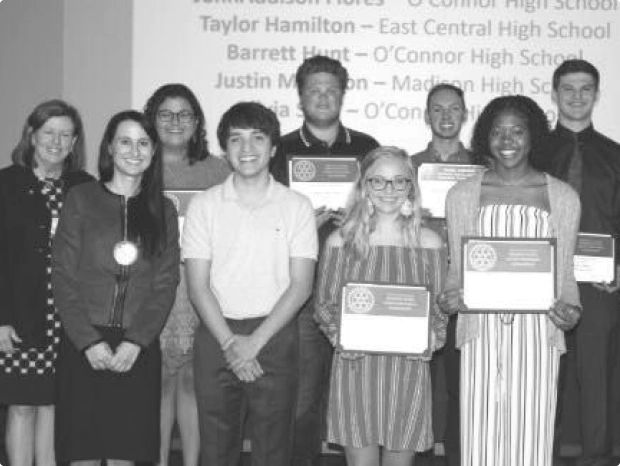 Scholarship recipients standing together with certificates