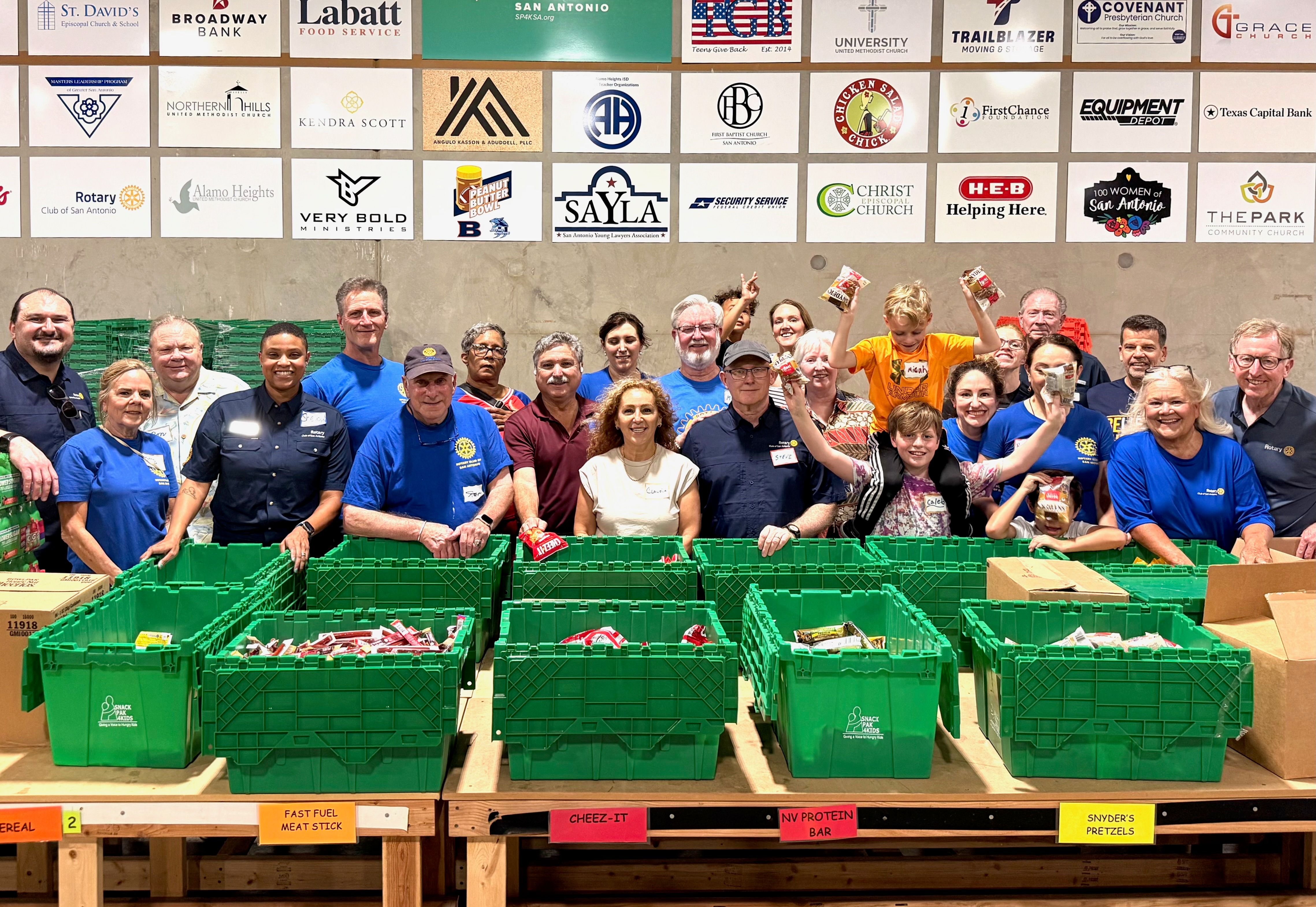 Volunteers assembling weekend food packs
