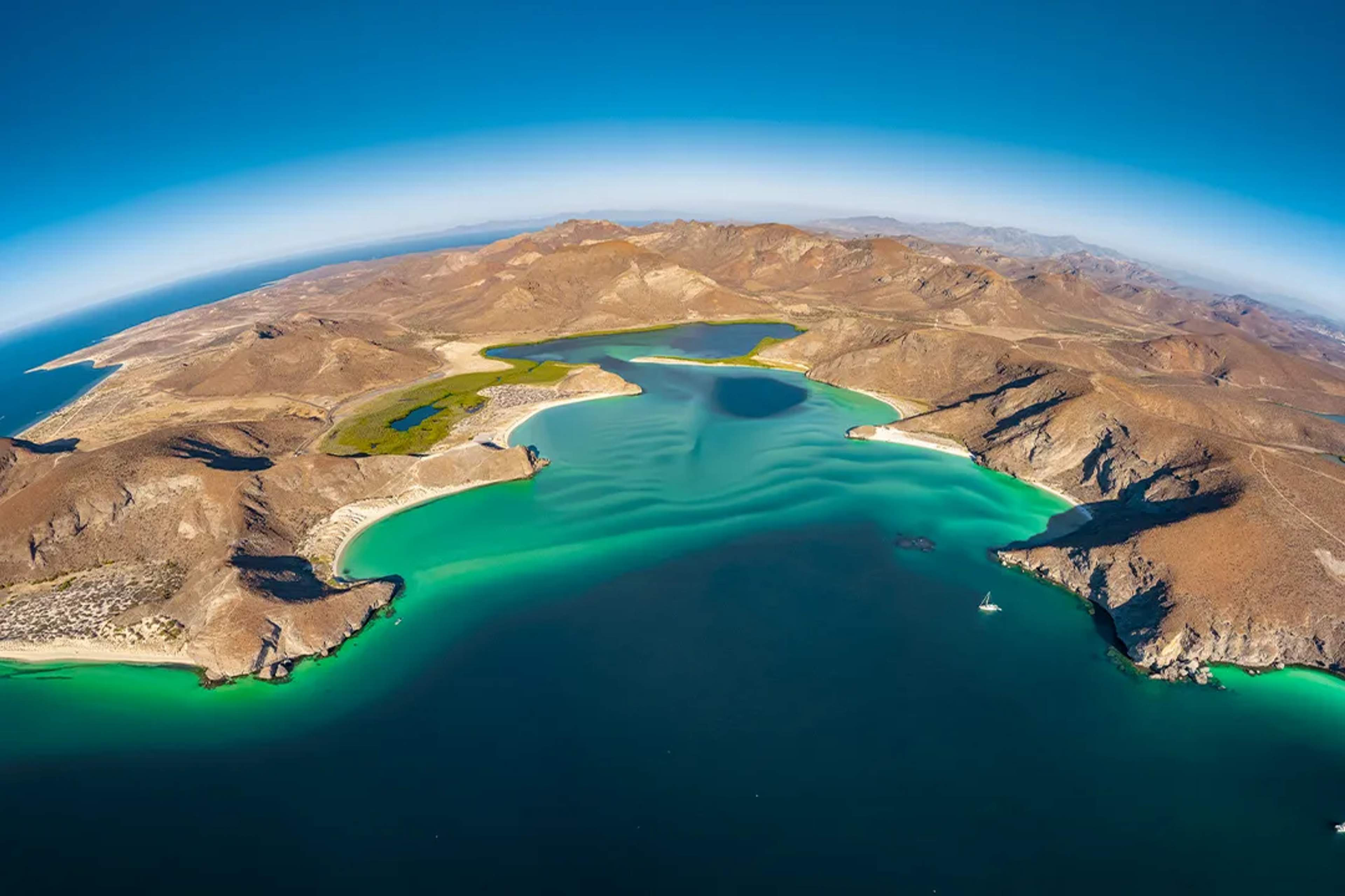 Aerial view of Espíritu Santo Island turquoise bays and desert landscape during a scenic tour in La Paz, Baja California.