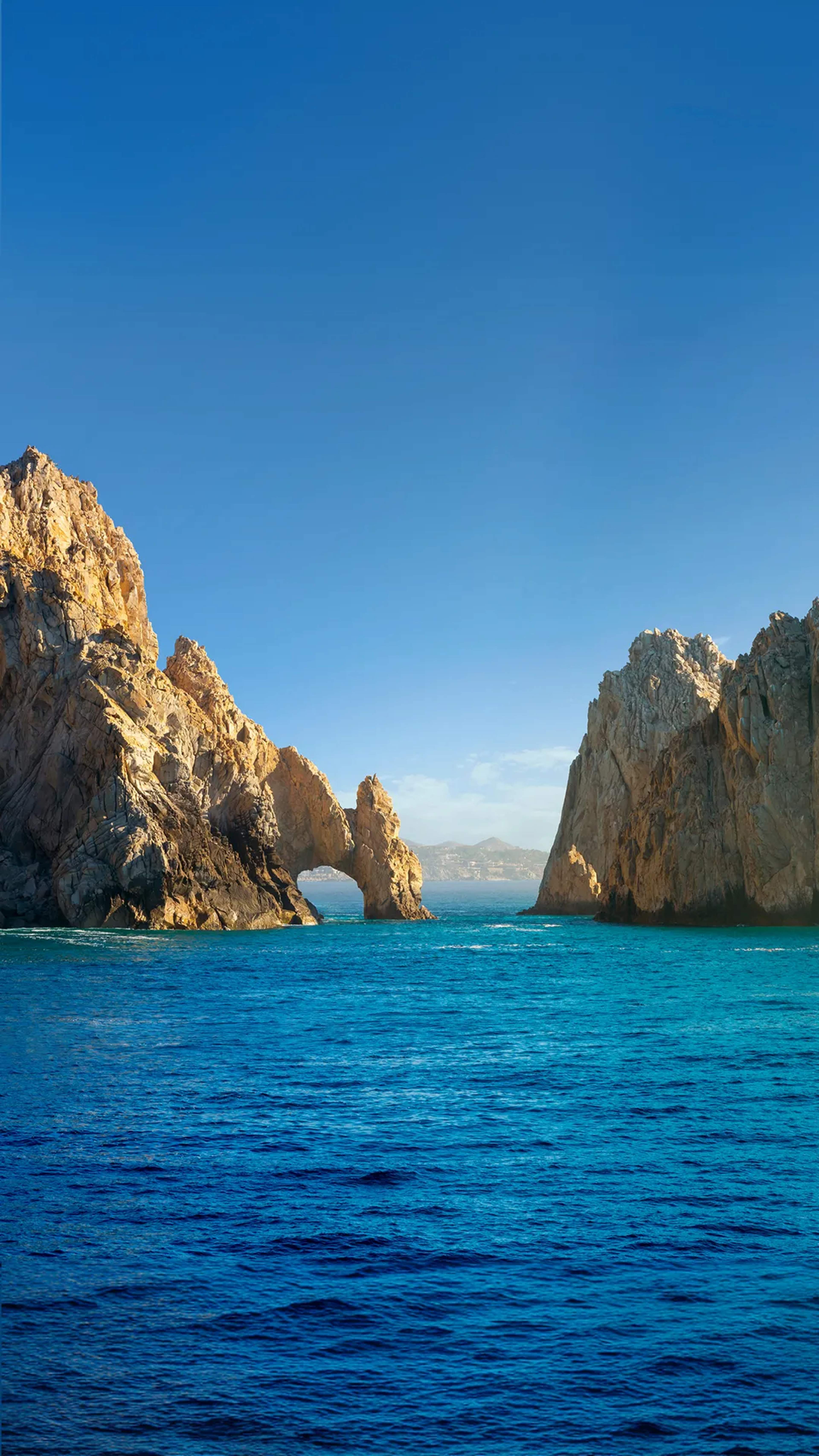 Clear skies and sunny weather over Cabo's iconic rock formations, perfect for outdoor activities.