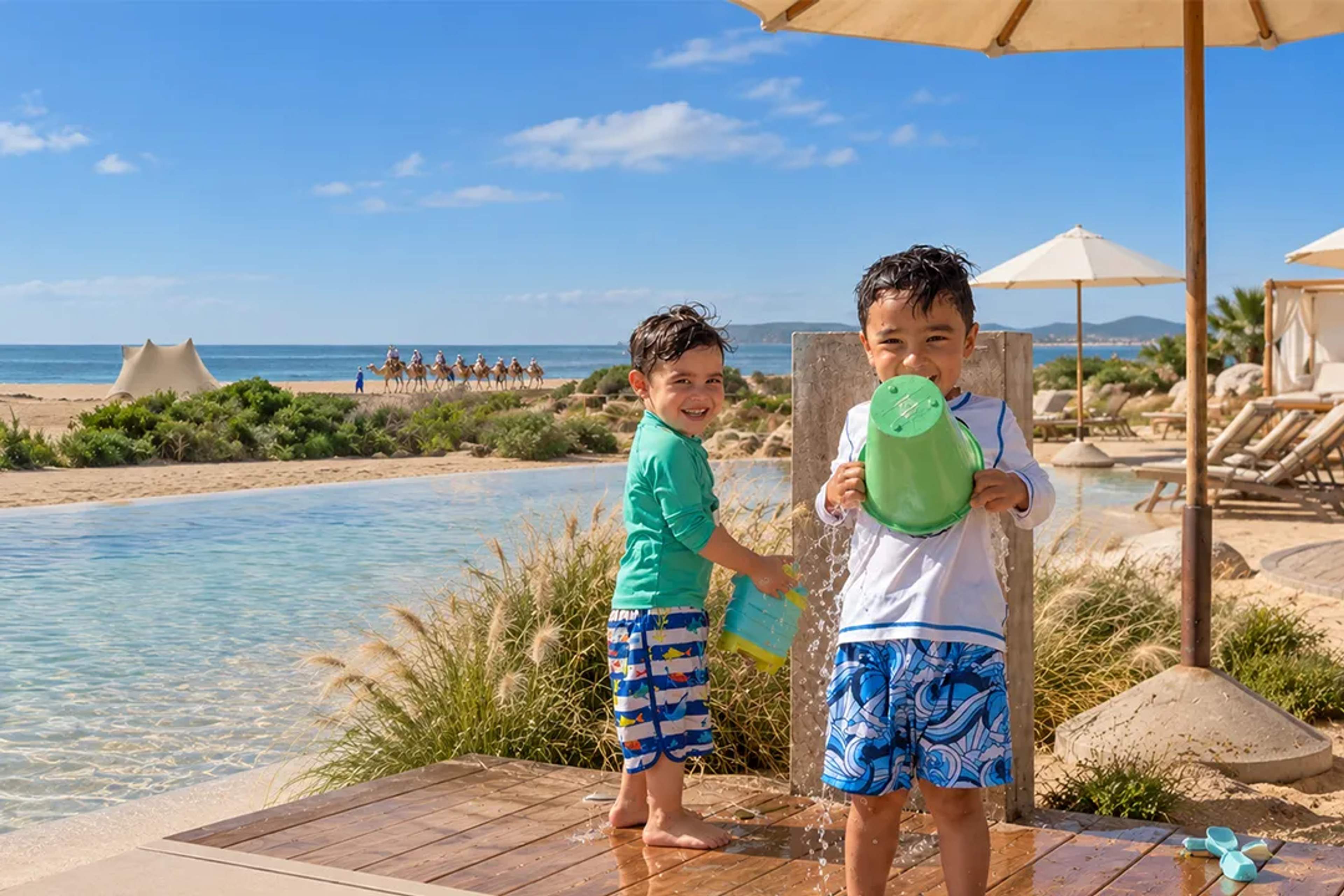 Toddlers play by the pool at Tierra Sagrada Beach Club during a family day with Cabo Adventures.