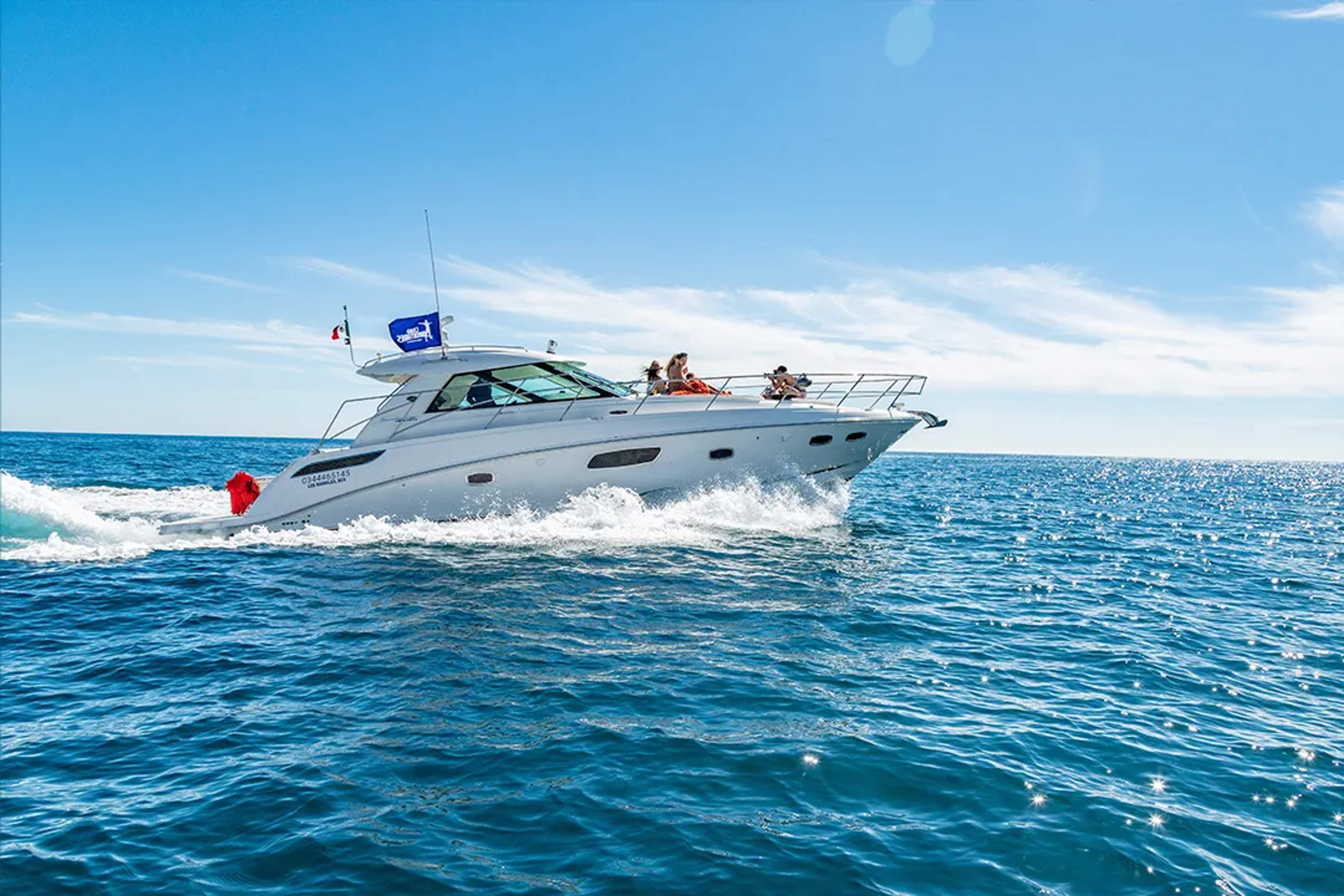 Luxury yacht cruising through the waters of Los Cabos, offering a private charter experience with open ocean views