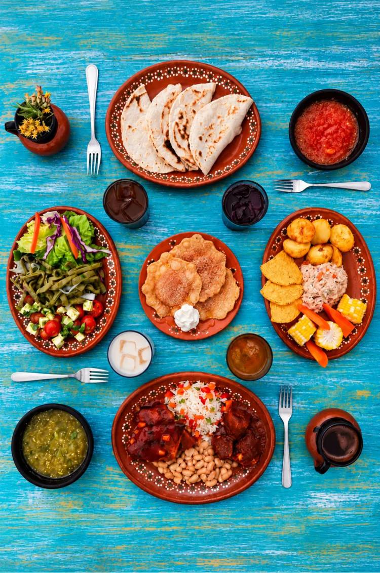 Mexican buffet at Tierra Sagrada with quesadillas, salads, rice, beans and salsas on a turquoise table.