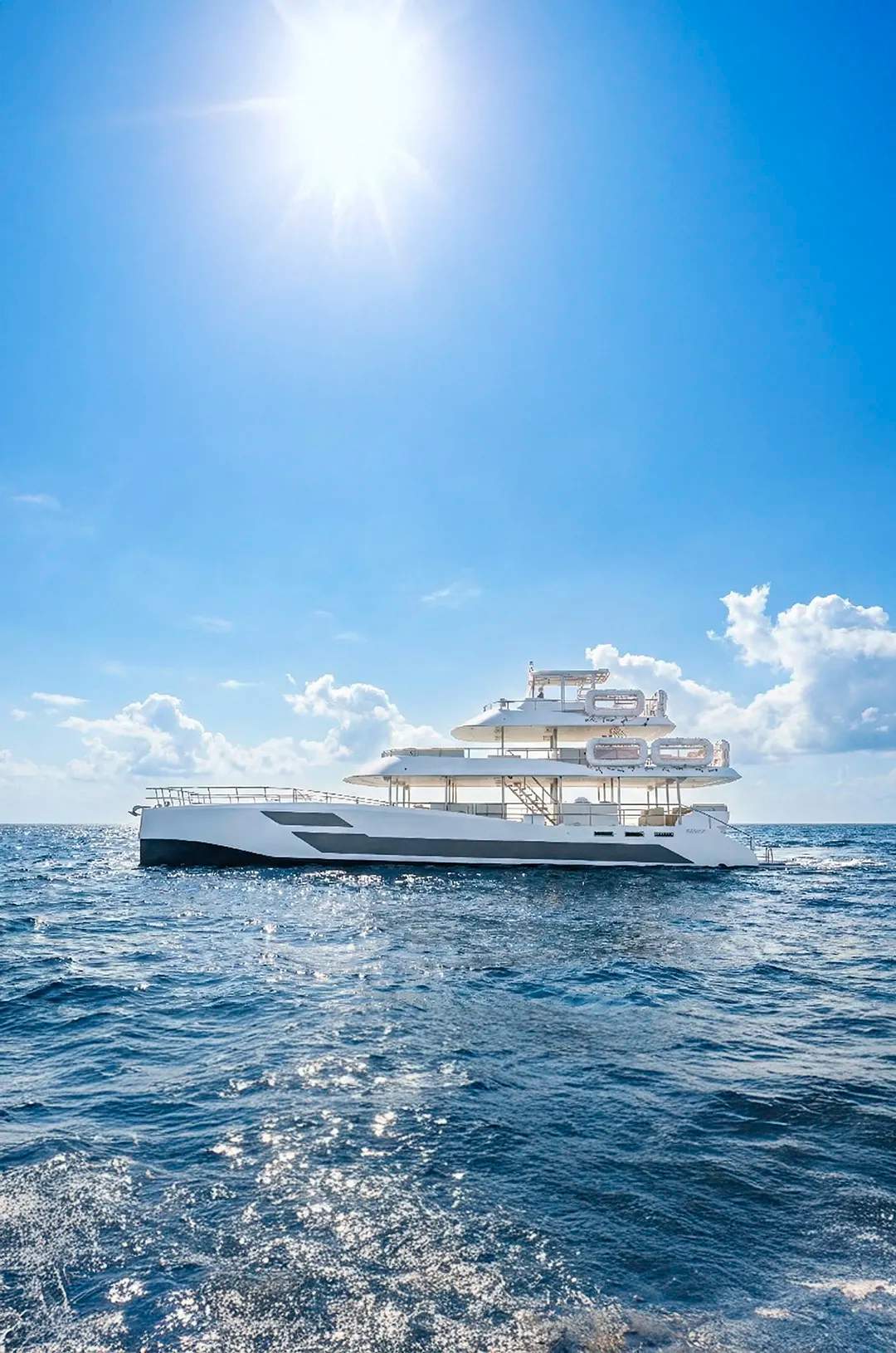 TwentyFive premium 100-ft catamaran sailing in Cabo San Lucas, triple-deck design, open sea views and luxury day cruise.