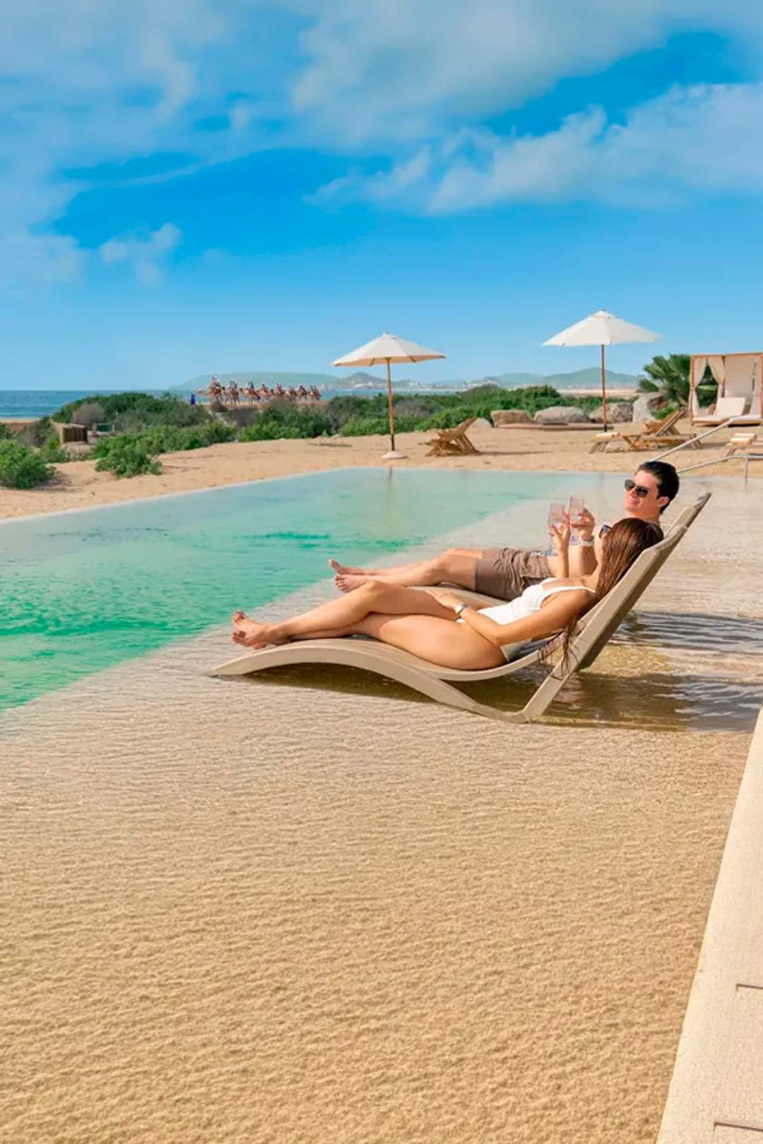 Woman enjoying the pool at Tierra Sagrada Beach Club, Los Cabos, Mexico.