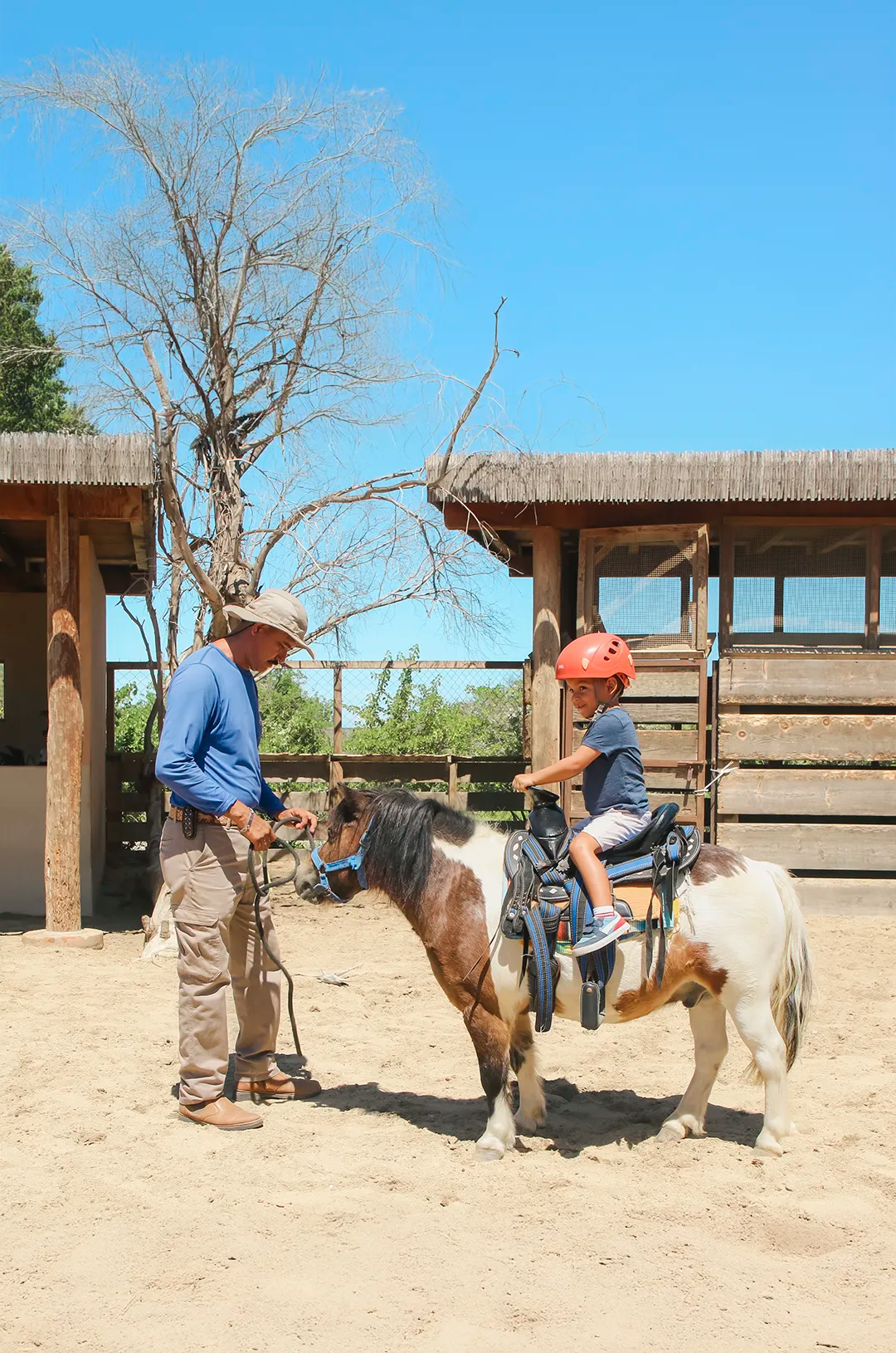 Child enjoying pony ride with guide at Kids Adventure Park in Tierra Sagrada Cabo San Lucas
