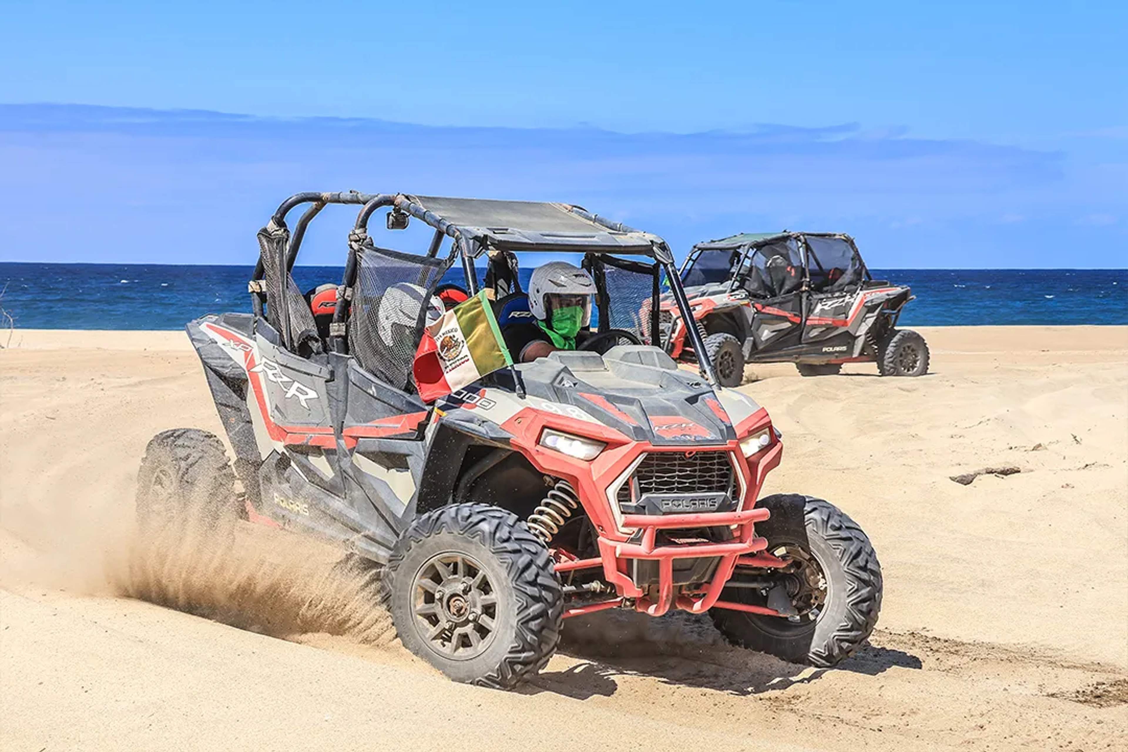 UTV RZR adventure riding across sandy beaches and desert terrain on an off-road tour in Los Cabos