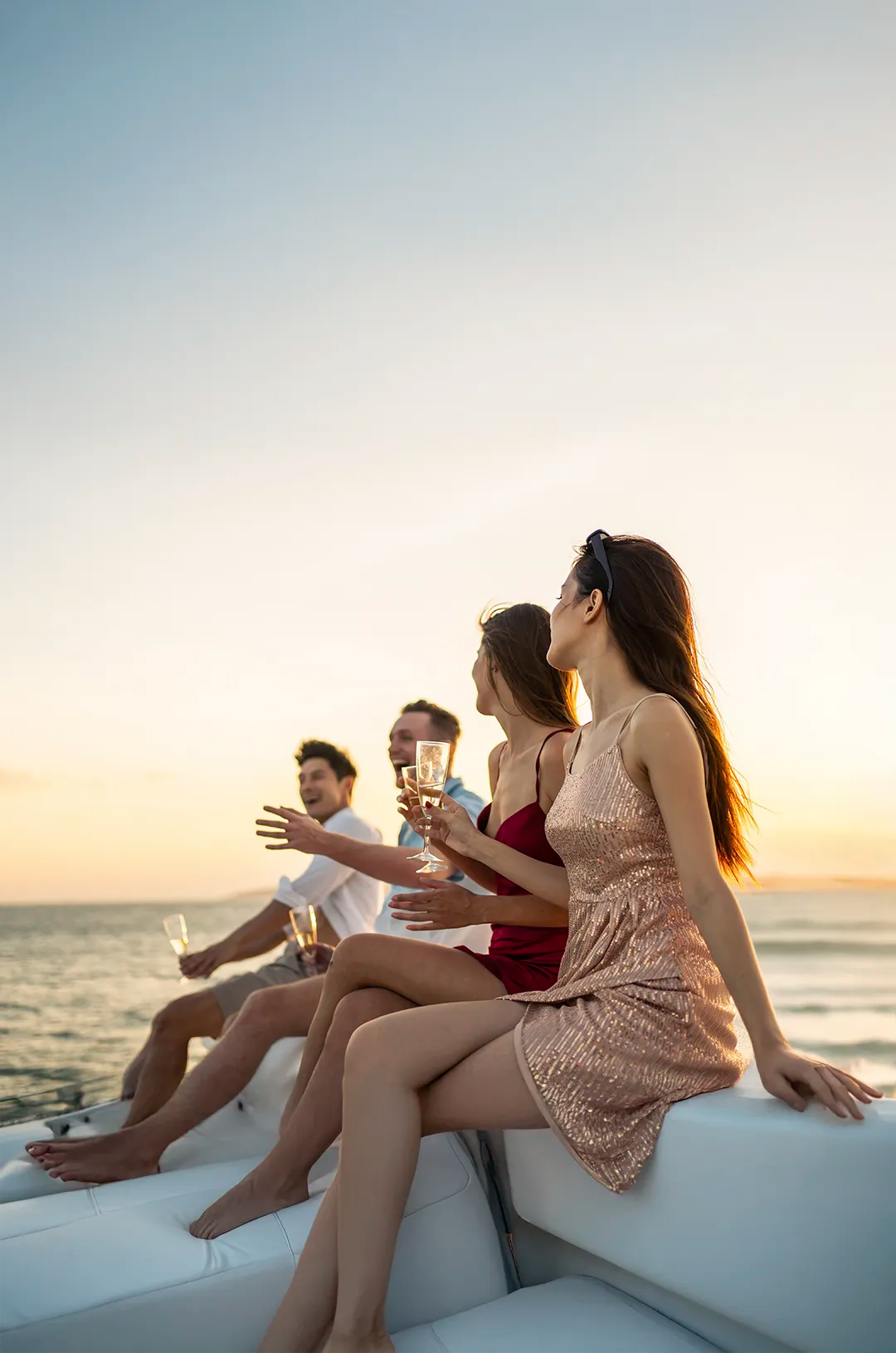 Group enjoying champagne and sunset views on a luxury catamaran in Los Cabos.