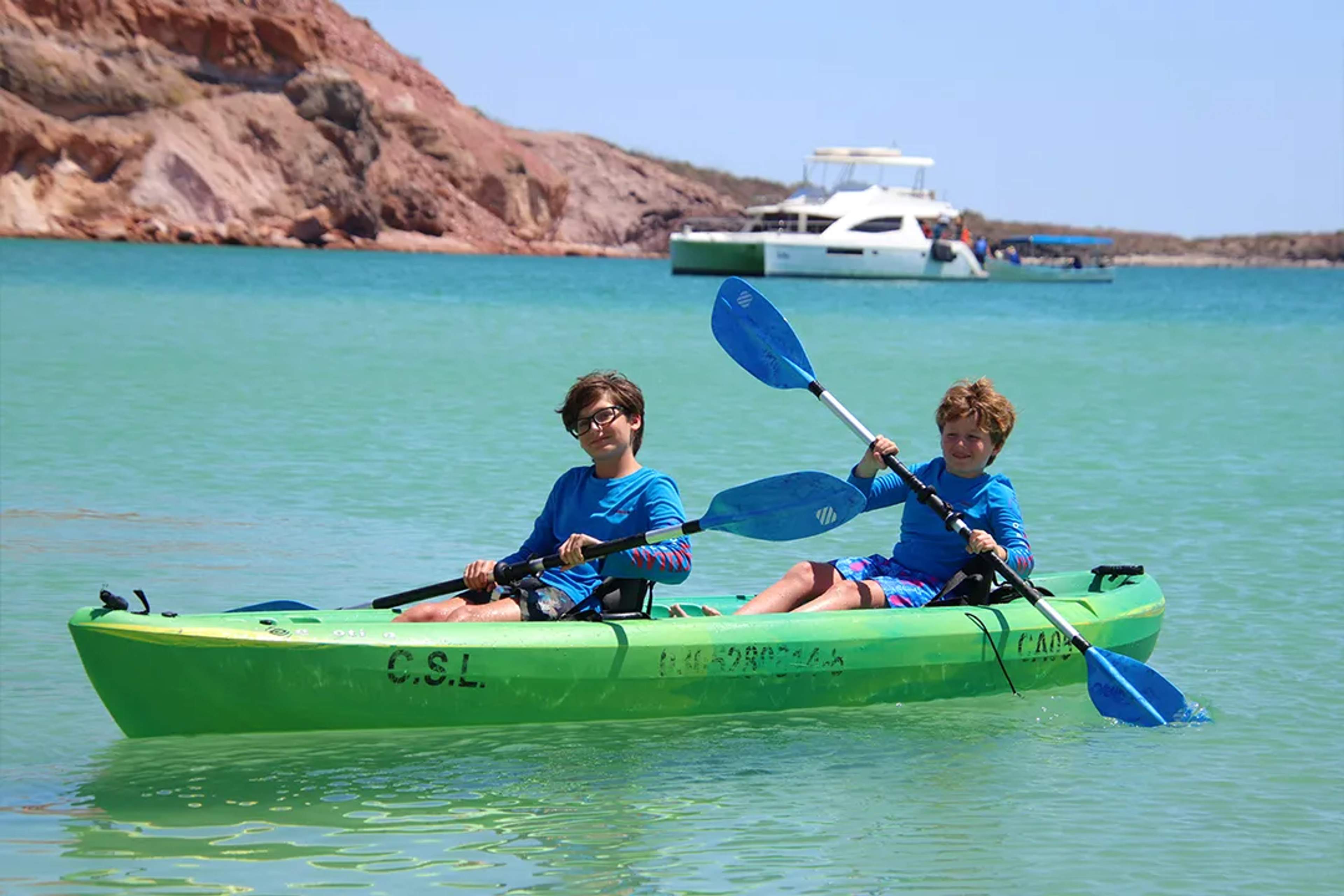 Children Kayaking Through The Turquoise Waters Of Balandra Bay During A Family Adventure In La Paz