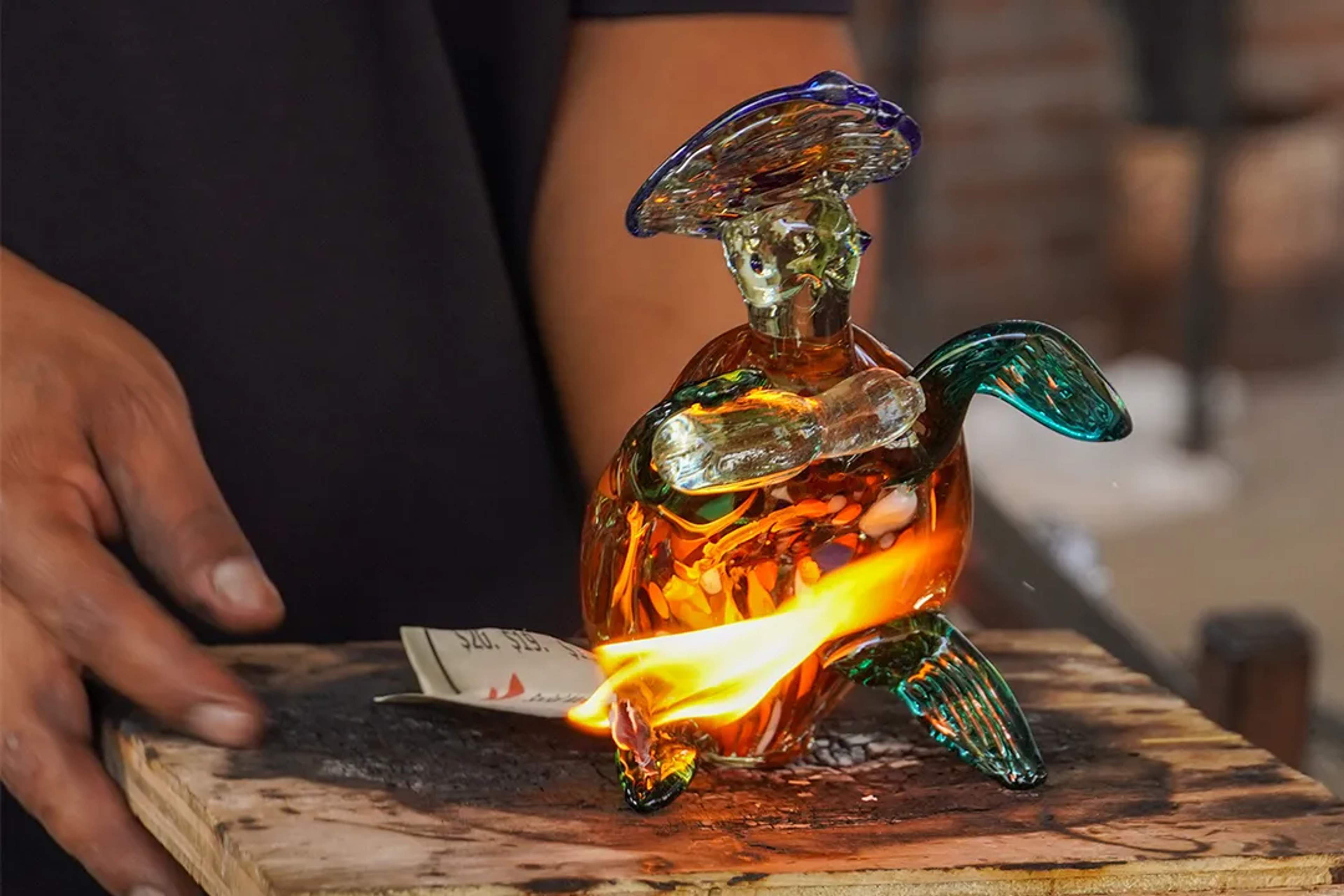 Colorful glass turtle sculpture crafted by hand, glowing with vibrant hues and artisan detail.