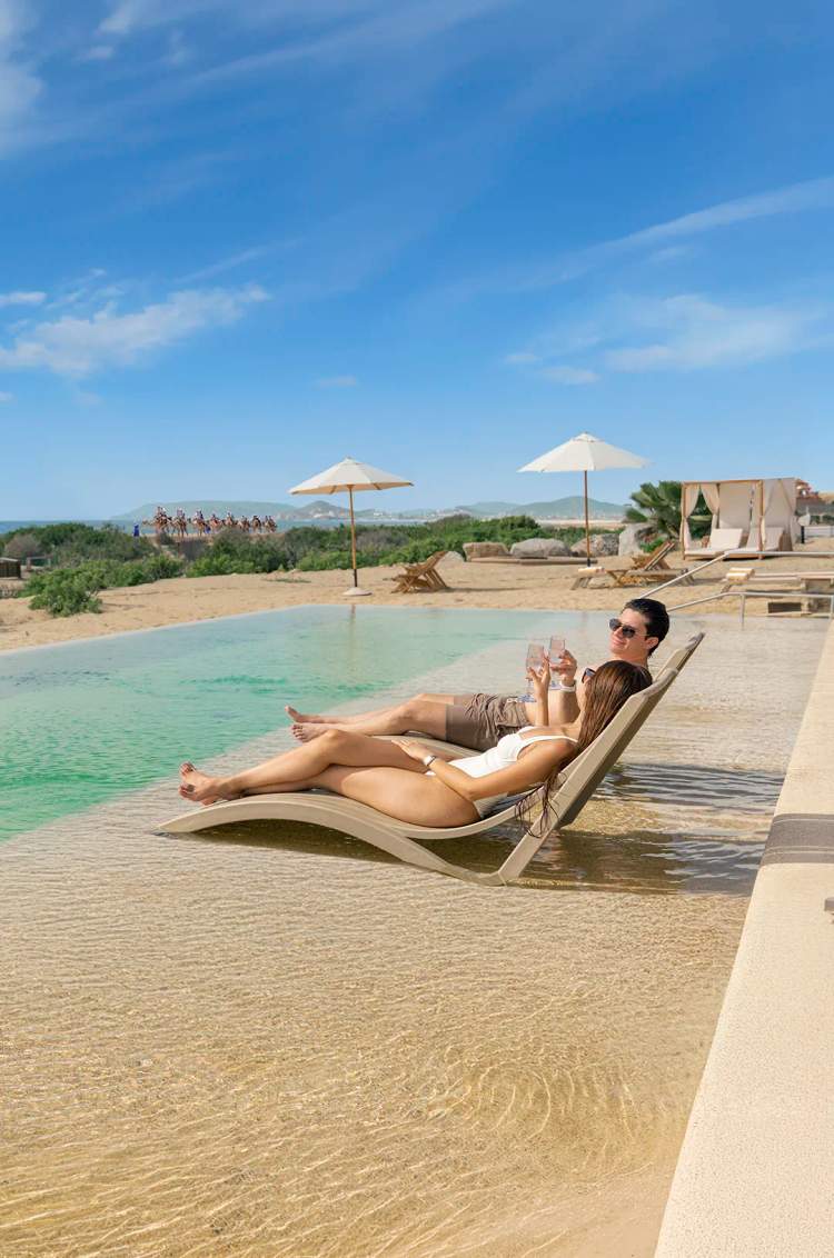 Couple enjoying the pool at Tierra Sagrada Beach Club