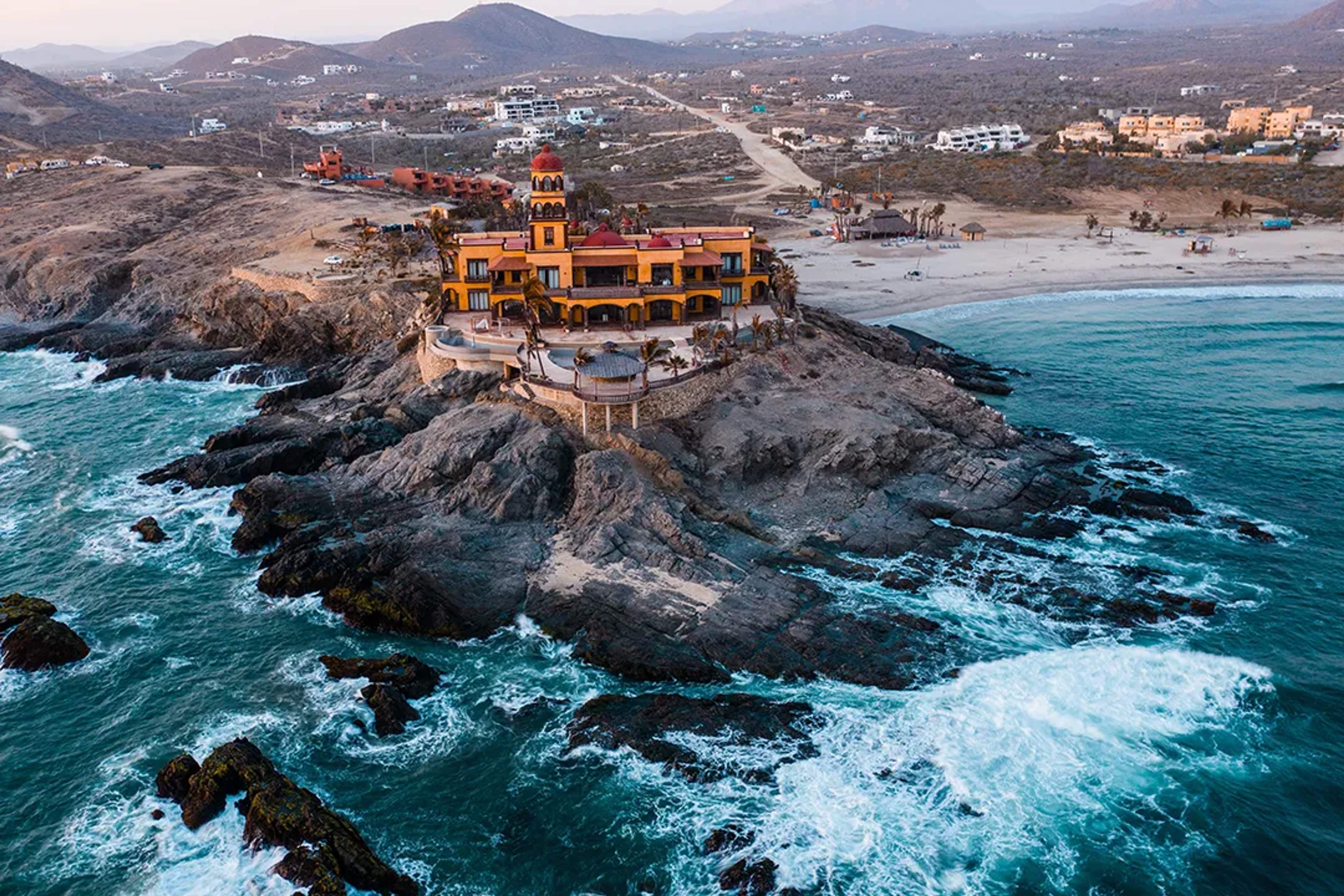Iconic beachfront mansion on rocky coast in Cerritos, Baja California Sur.