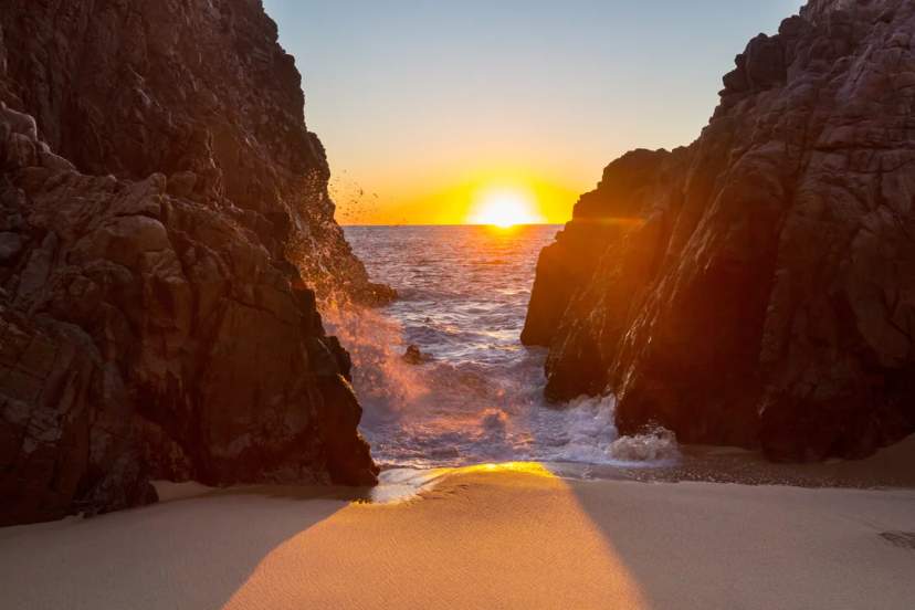 Witness a breathtaking sunset between Cabo’s cliffs, where golden light meets the roaring ocean.