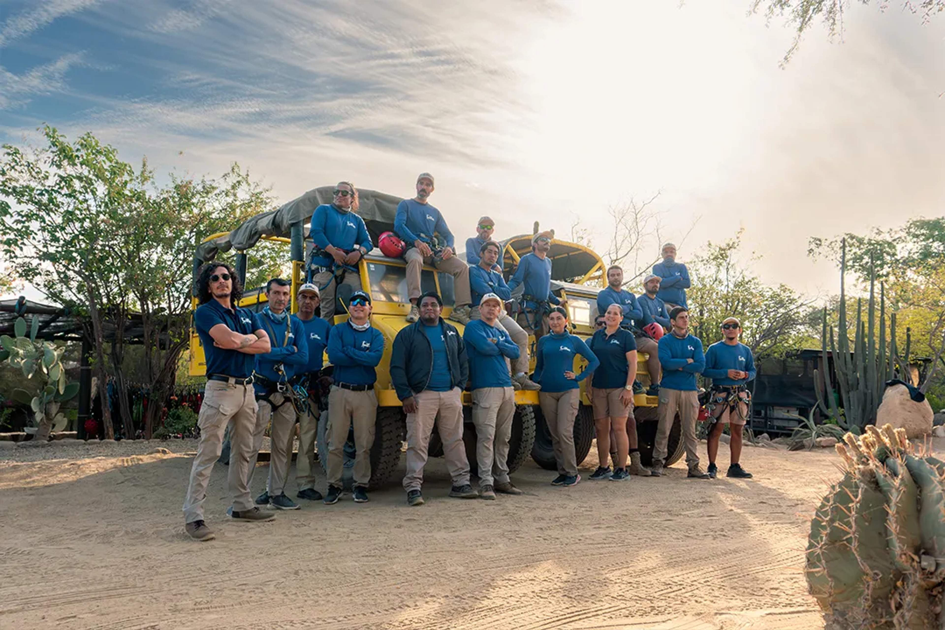 Outdoor adventure guides team in Cabo San Lucas posing with off-road transport before zipline and ATV tour