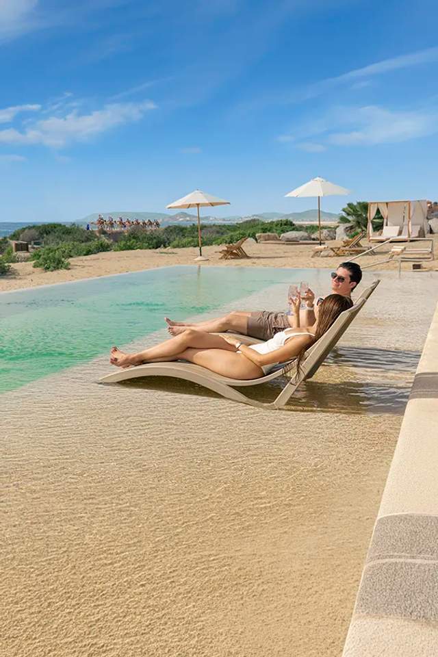 Woman enjoying the pool at Tierra Sagrada Beach Club, Los Cabos, Mexico.
