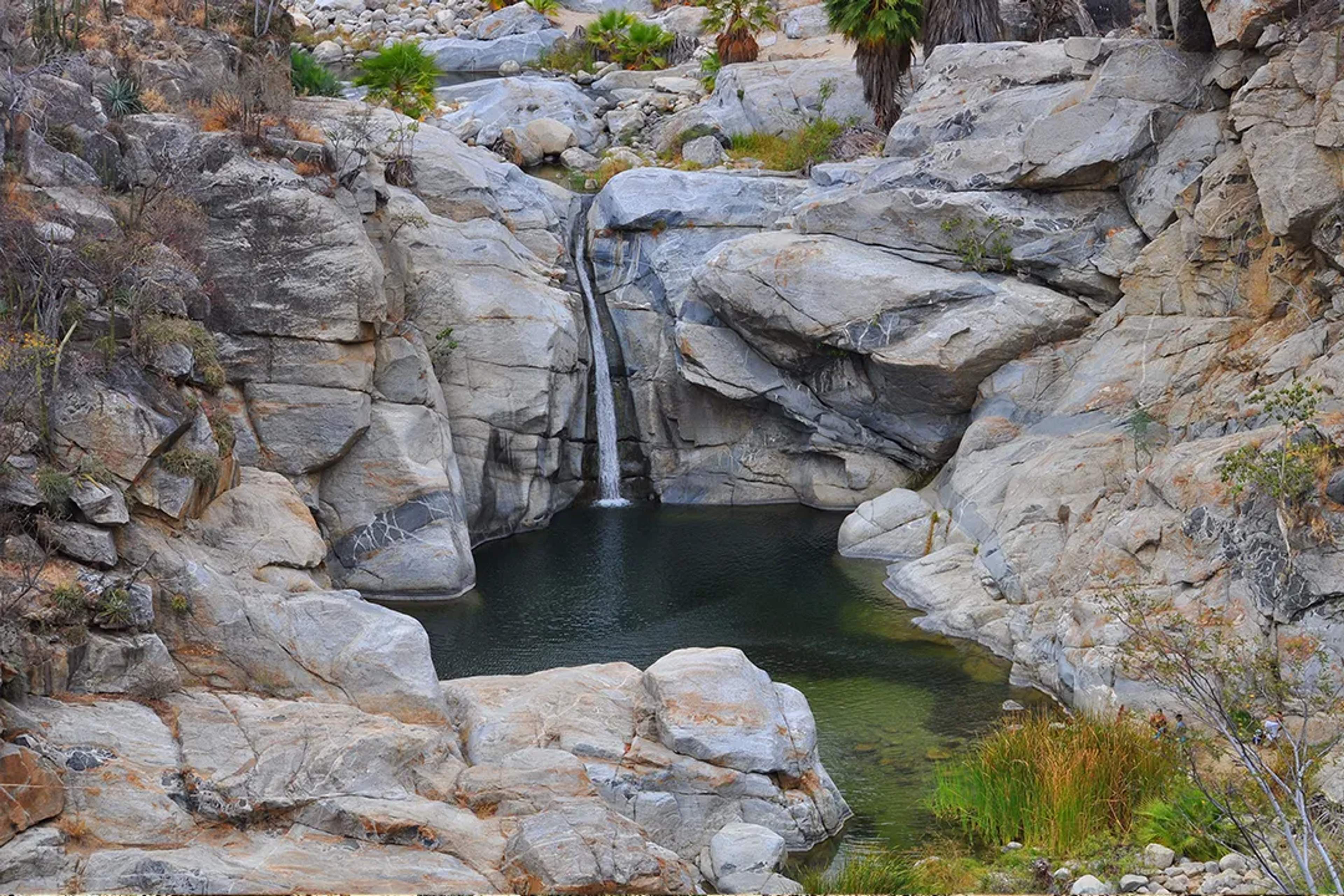 Hidden waterfall and natural pool among rocky cliffs in the Sierra de la Laguna, Baja California Sur.