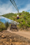 Woman ziplining over lush terrain and an off-road vehicle driving on a dusty trail through desert vegetation.