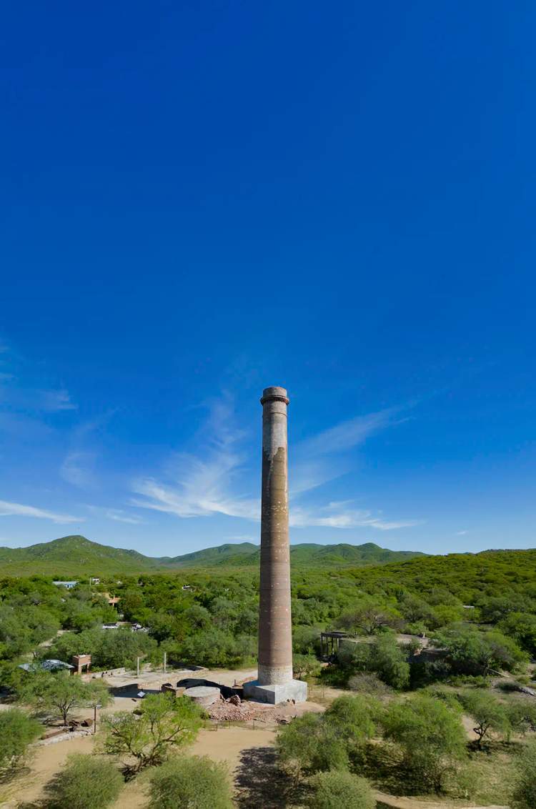 La chimenea La Ramona en El Triunfo, Baja California Sur, ícono del pasado minero rodeado de paisaje desértico y montañas.