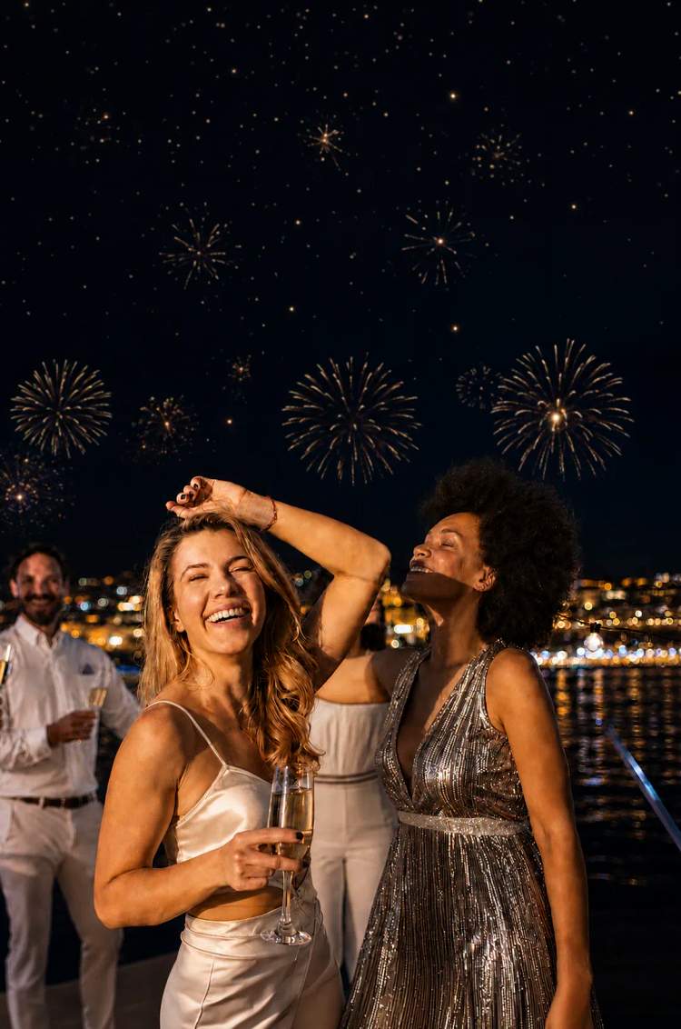 Friends dance and toast in New Year’s Eve Disco Fever Party aboard Oceanus by Cabo Adventures in Cabo.