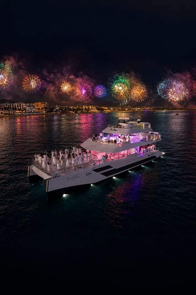 New Year’s Eve Golden Midnight aboard TwentyFive catamaran by Cabo Adventures with fireworks over Cabo San Lucas Bay.